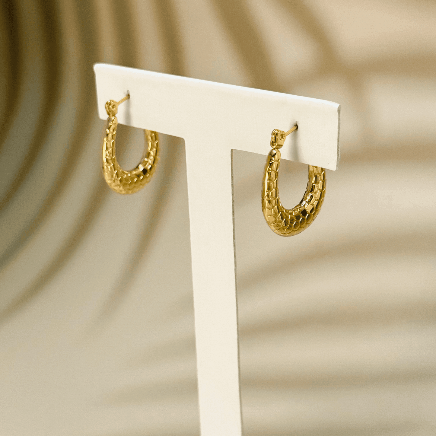 Gold textured hoop earrings with a honeycomb pattern, waterproof and hypoallergenic. Perfect for everyday wear and layering.