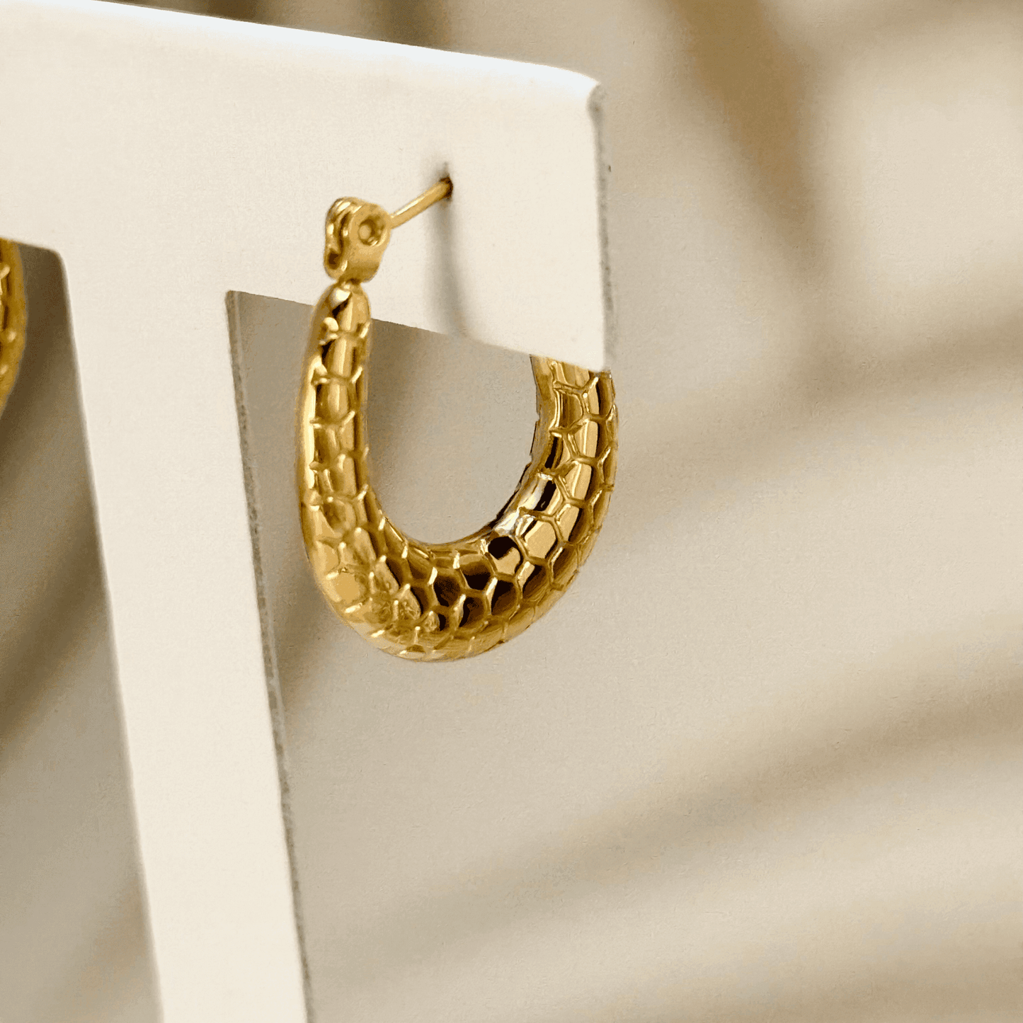 Gold textured hoop earrings with a honeycomb pattern, waterproof and hypoallergenic. Perfect for everyday wear and layering.