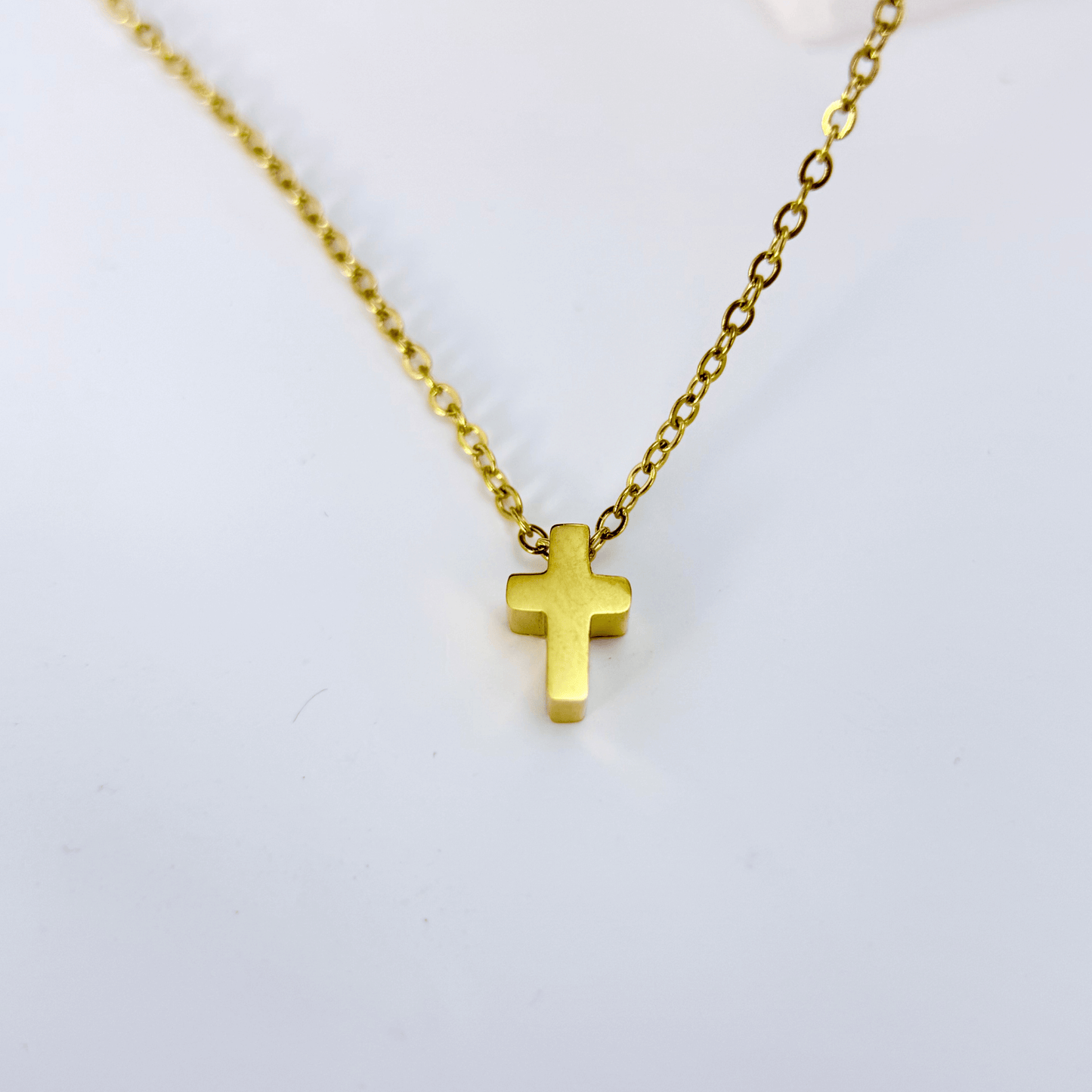 Gold tiny cross necklace symbolising faith and grace – MXW Jewellery