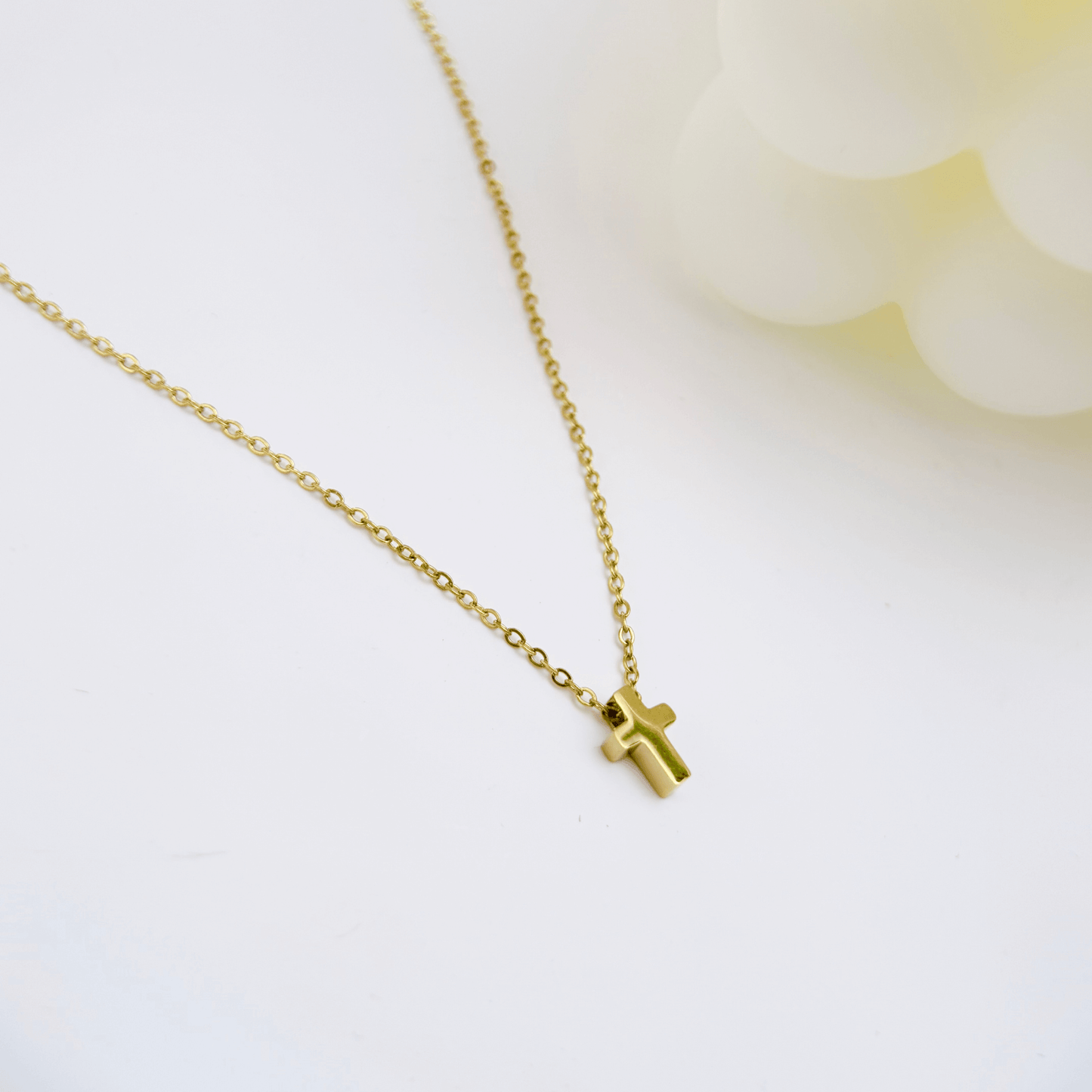 Gold tiny cross necklace symbolising faith and grace – MXW Jewellery