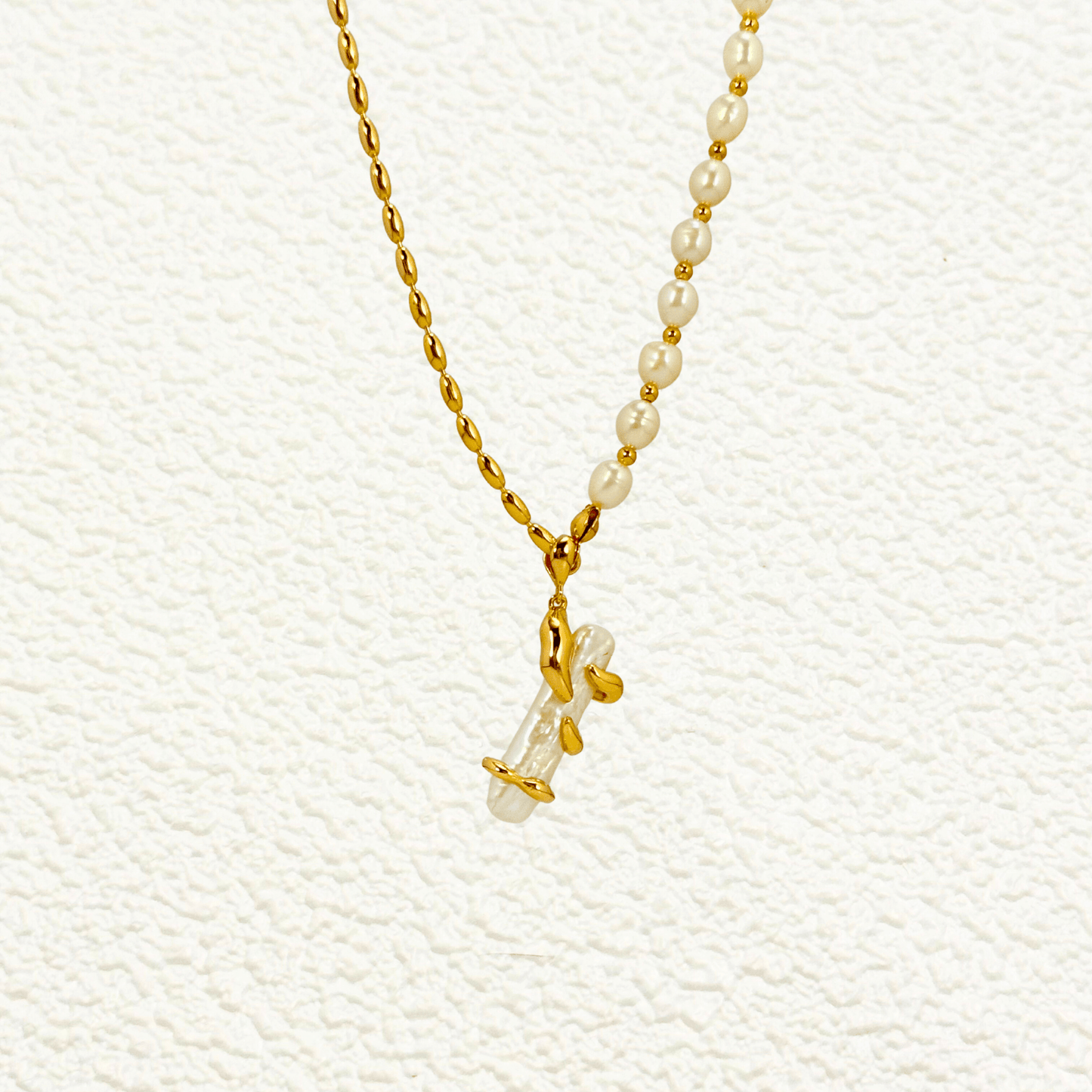 necklace with gold vine-wrapped pearl pendant on half pearl, half gold beaded chain