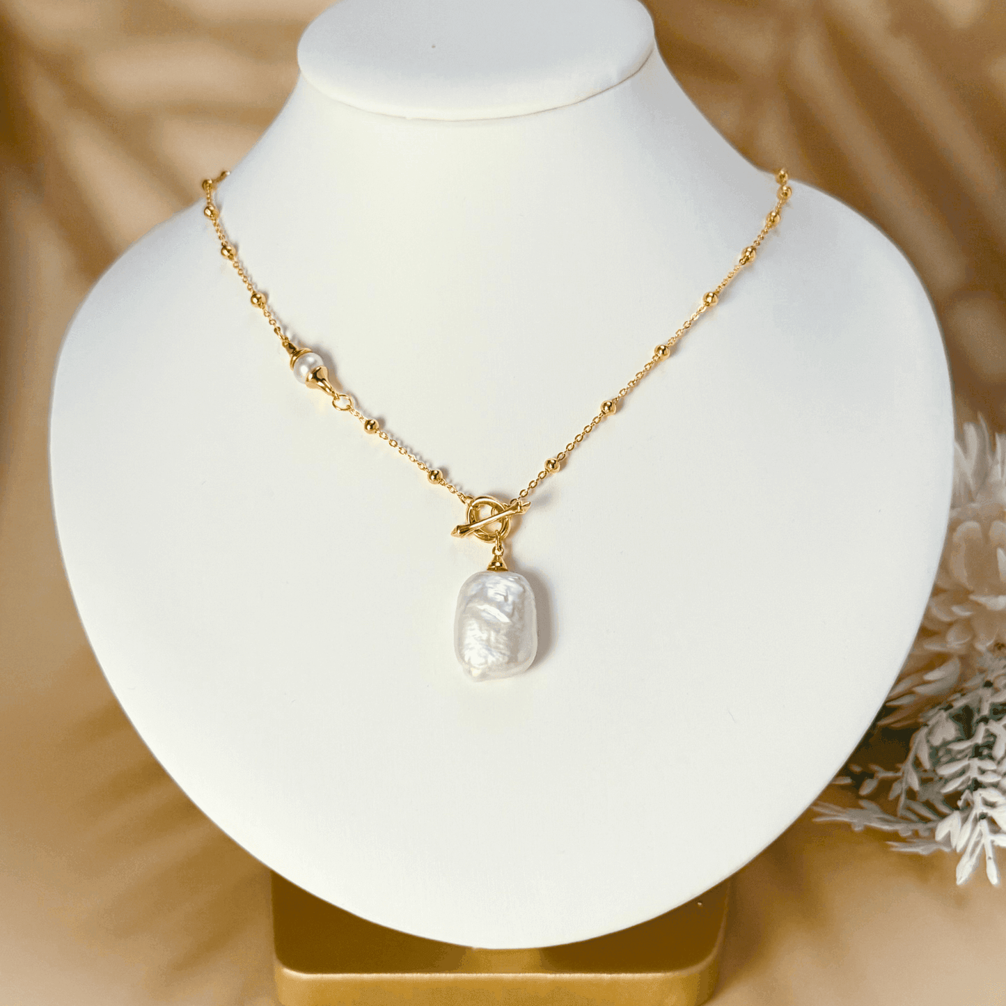 Gold vintage baroque pearl necklace with freshwater pearl pendant on a satellite bead chain and a toggle clasp, crafted in gold-plated sterling silver.