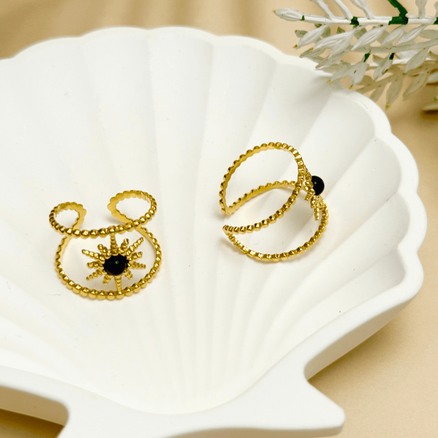 Lapis Sunburst Ring in gold with beaded twin bands and a navy lapis stone center. Waterproof and tarnish-resistant open ring with celestial sunburst design, worn on hand.