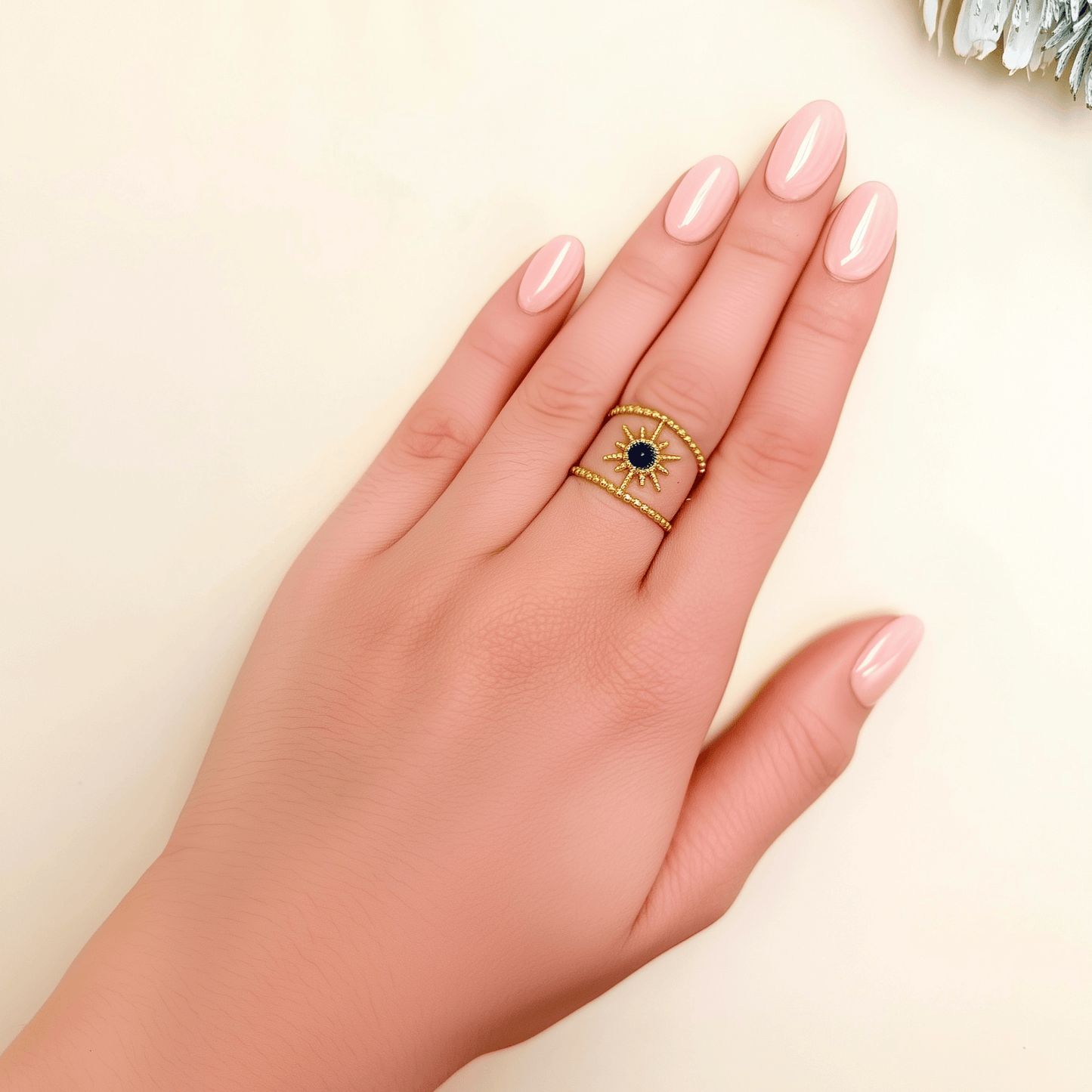 Lapis Sunburst Ring in gold with beaded twin bands and a navy lapis stone center. Waterproof and tarnish-resistant open ring with celestial sunburst design, worn on hand.