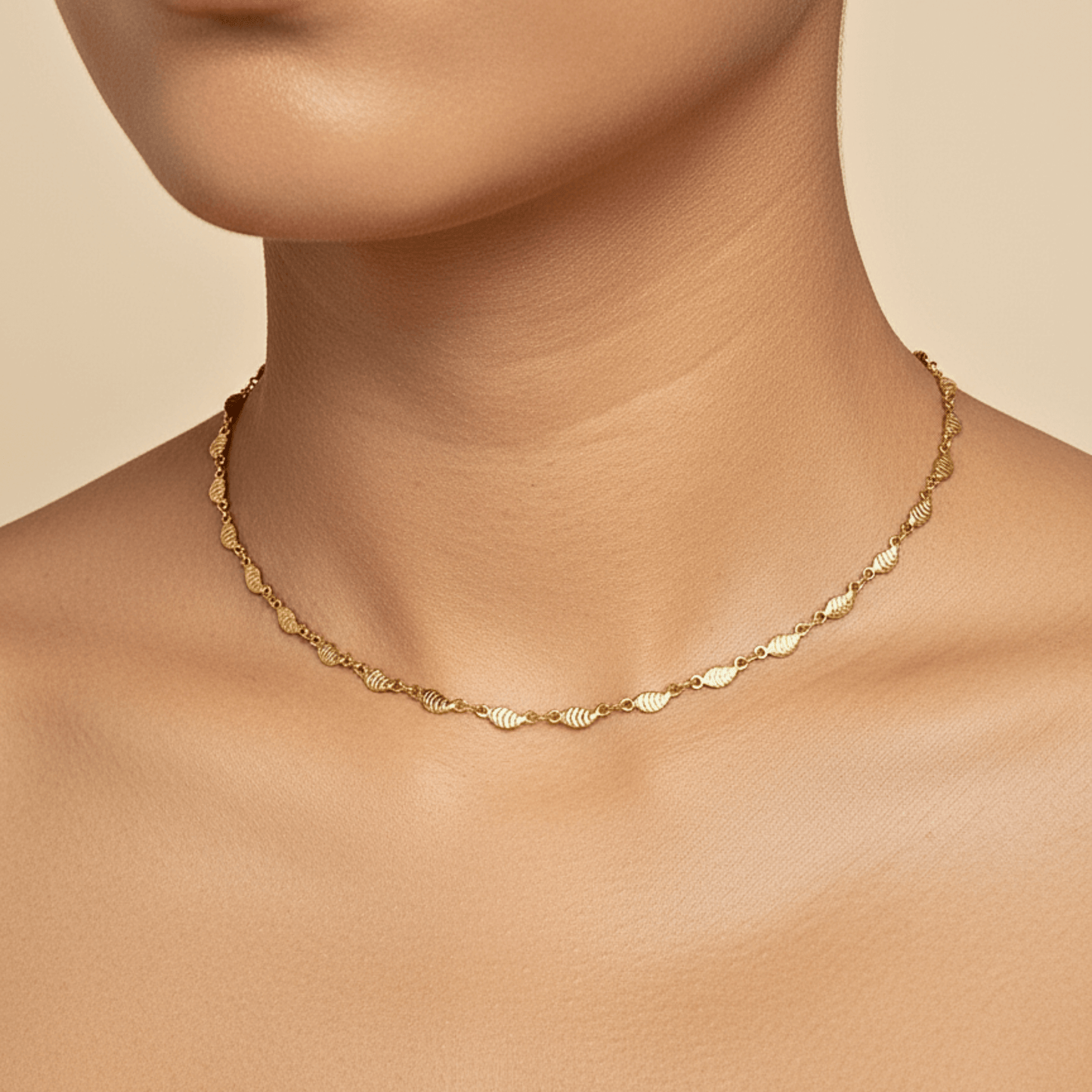 Elegant waterproof gold chain featuring textured leaf links with a minimalist, nature-inspired design