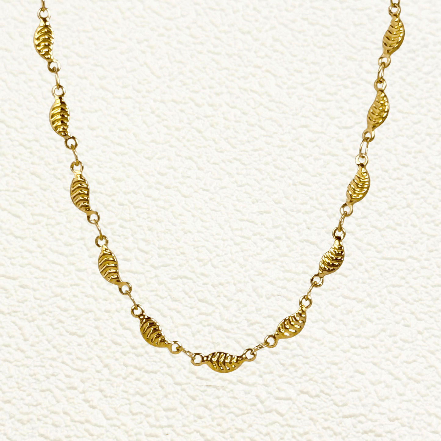 gold-toned leaf link chain made from stainless steel with delicate leaf-shaped links