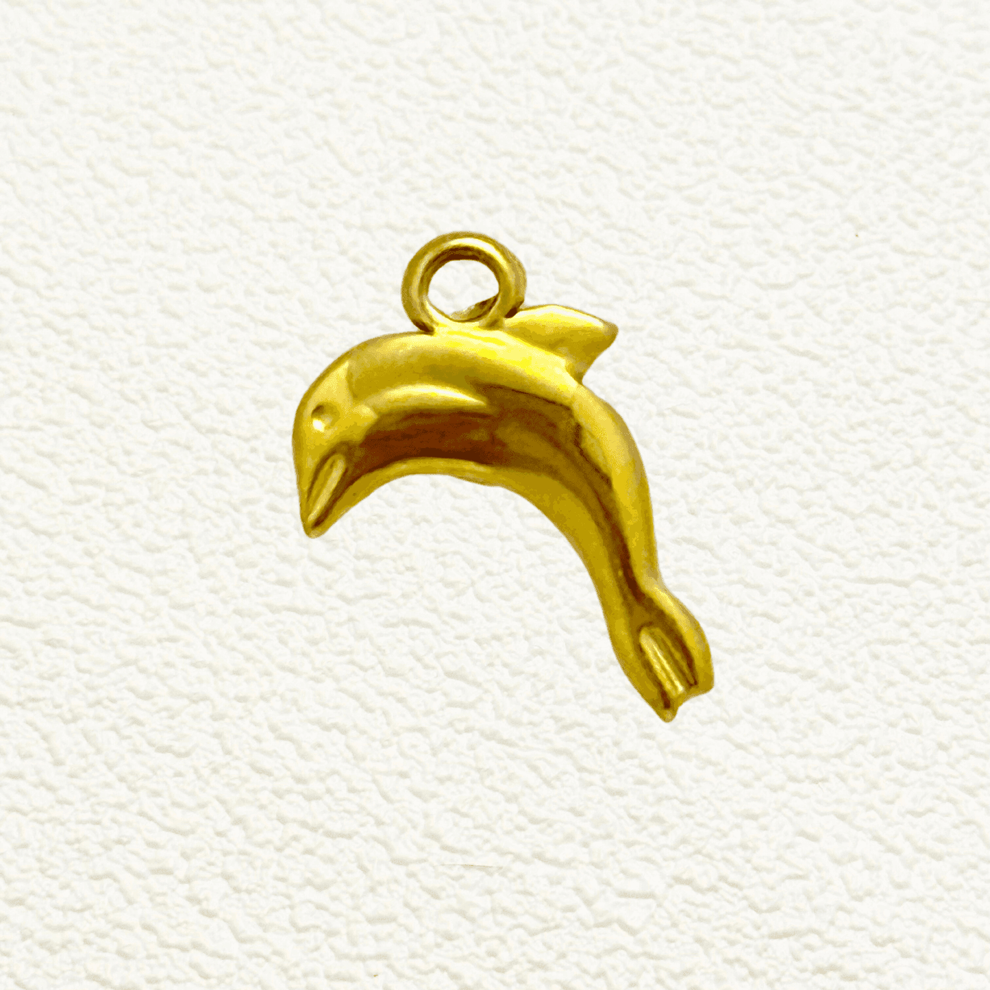 Gold dolphin charm in a leaping pose, ocean-themed PVD gold plated pendant