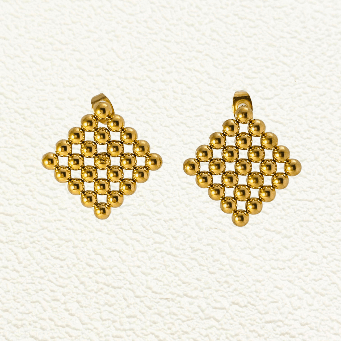 Lyra geometric gold mesh statement earrings, bold and structured gold-tone jewellery for a modern, stylish look.