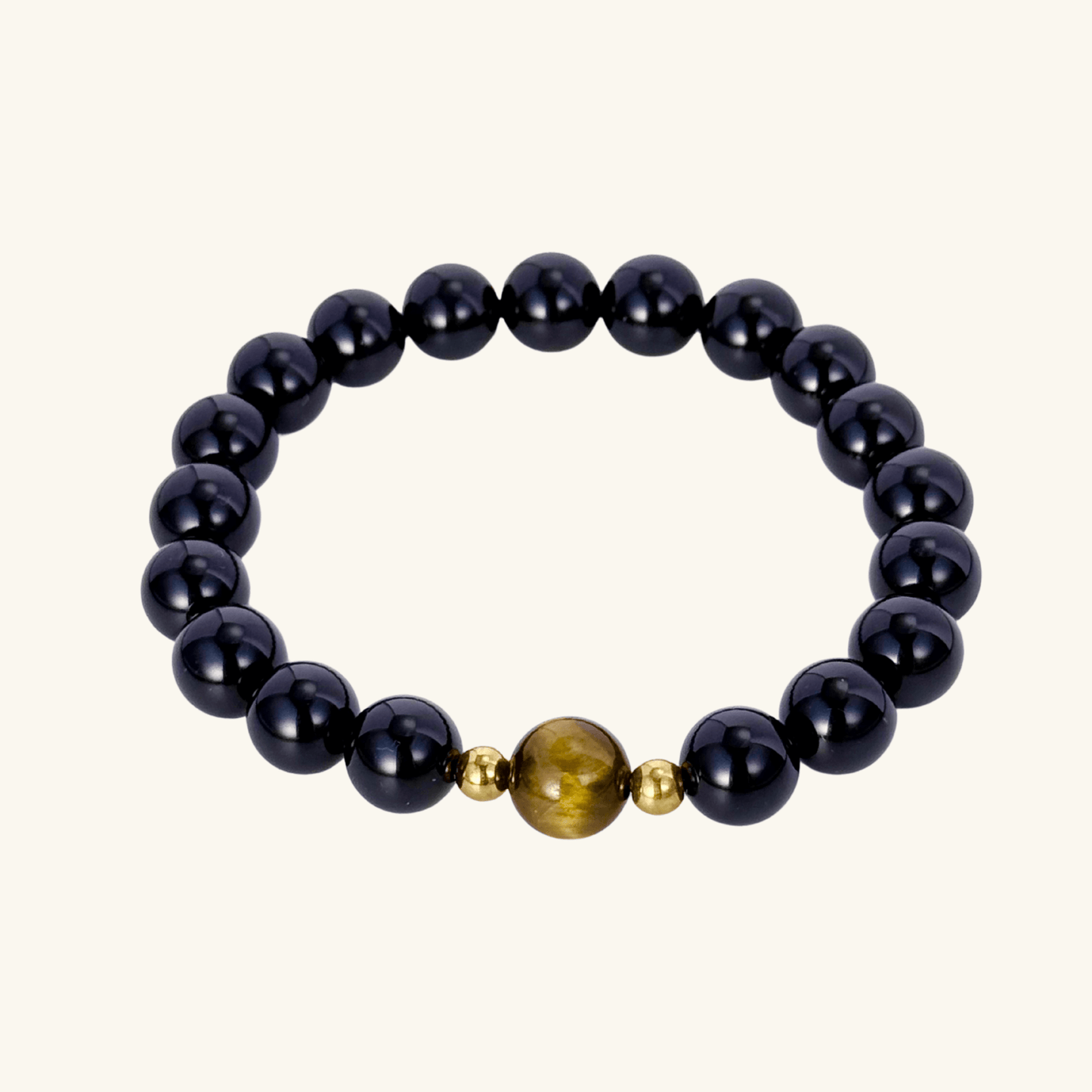 Men’s bracelet with polished black agate beads, single tiger’s eye gemstone, and gold accents on stretch cord.