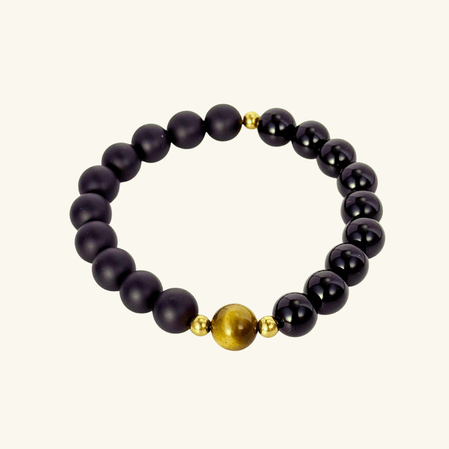 Men’s bracelet with polished black agate beads, single tiger’s eye gemstone, and gold accents on stretch cord.