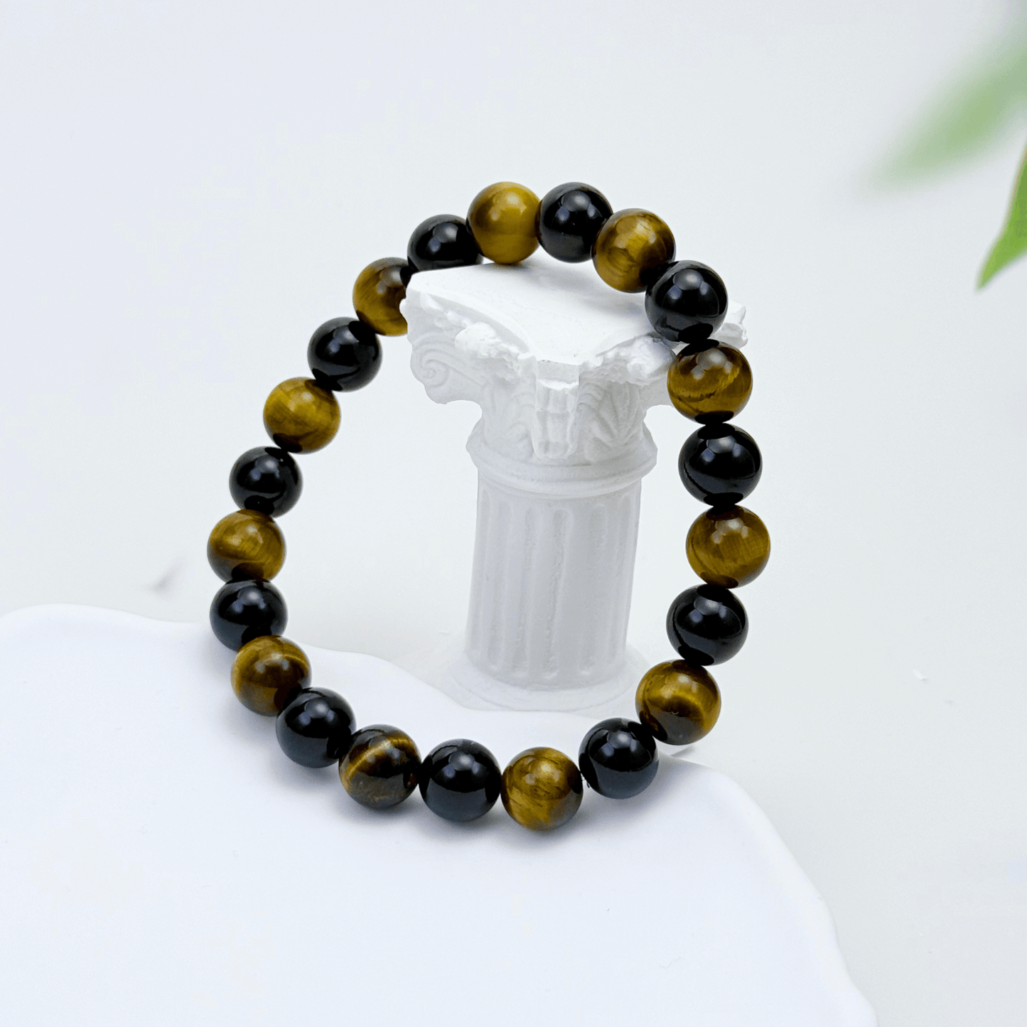 Handmade men’s bracelet with round black agate and tiger’s eye gemstone beads on elastic cord.