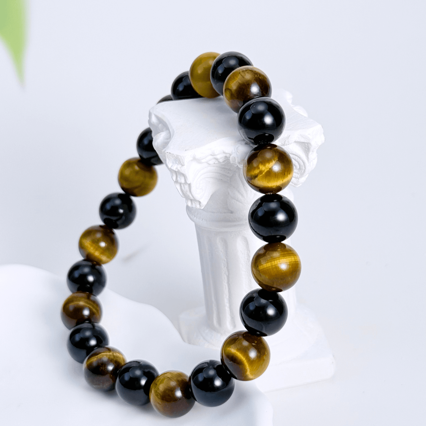Handmade men’s bracelet with round black agate and tiger’s eye gemstone beads on elastic cord.