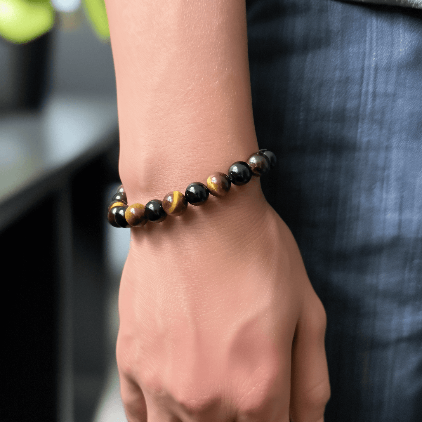Handmade men’s bracelet with round black agate and tiger’s eye gemstone beads on elastic cord.