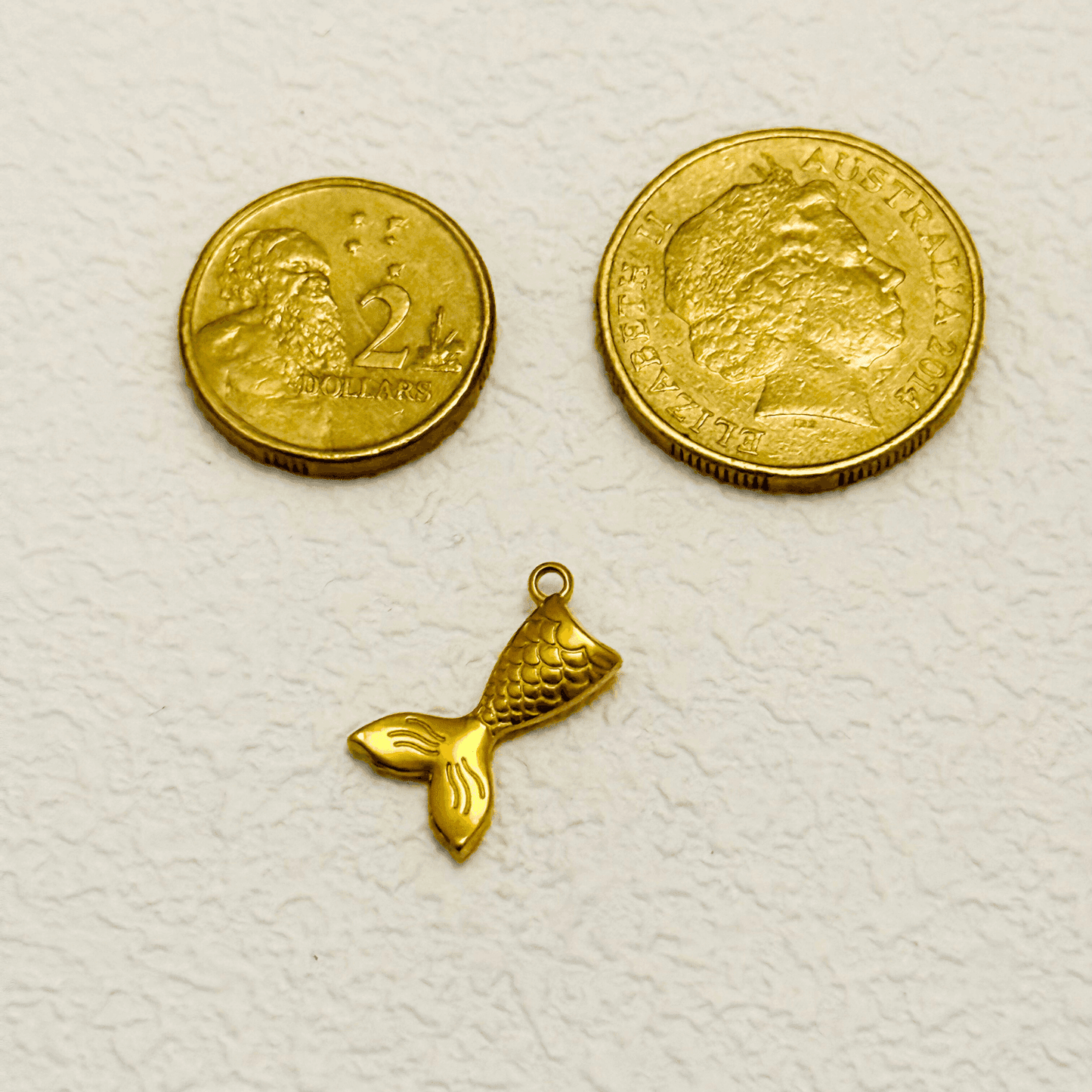Gold Mermaid Tail Charm with scale detail and curved fluke design
