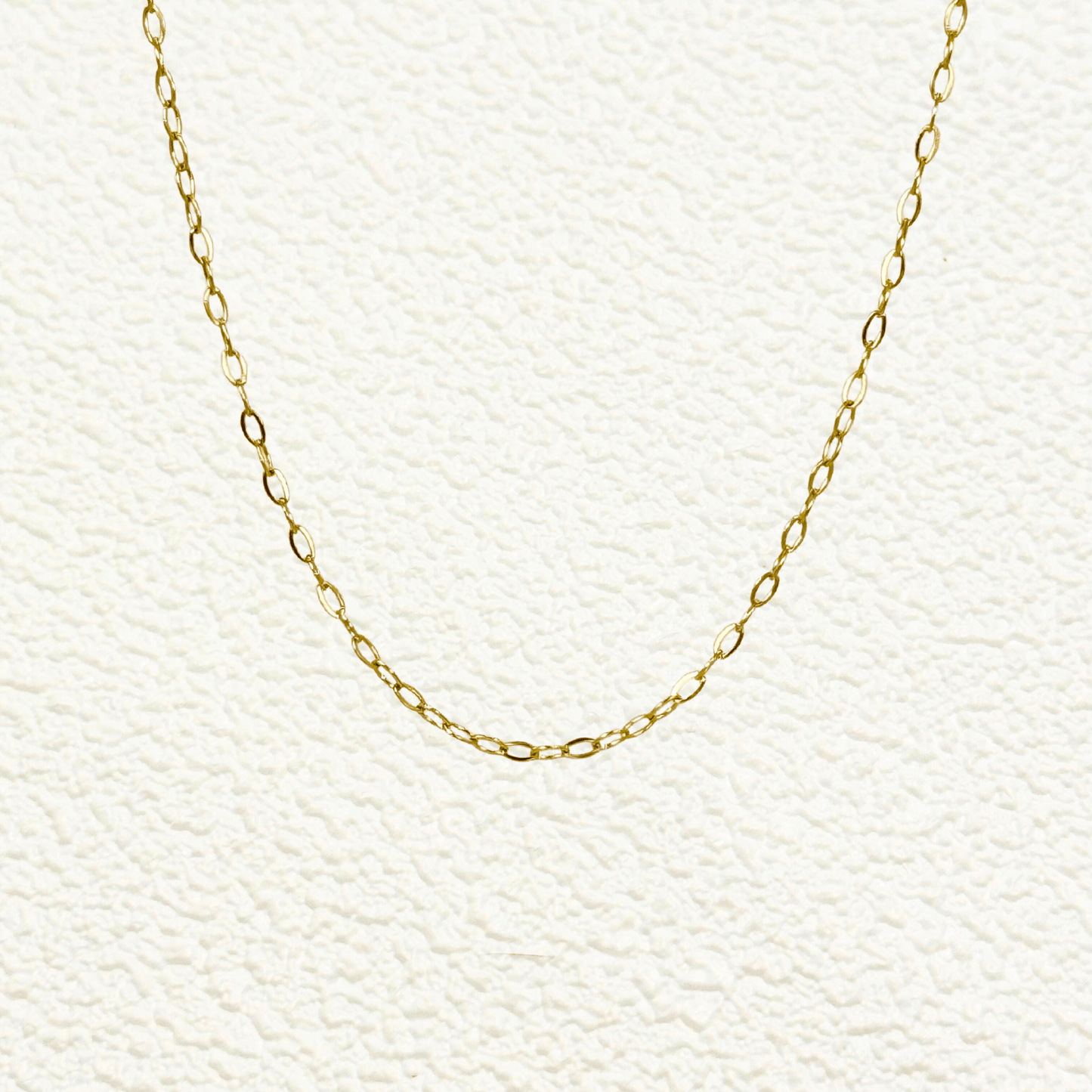 Mini paperclip link chain in 18K gold-plated stainless steel with fine elongated oval links, waterproof and tarnish-resistant, ideal for minimalist layering or adding custom charms