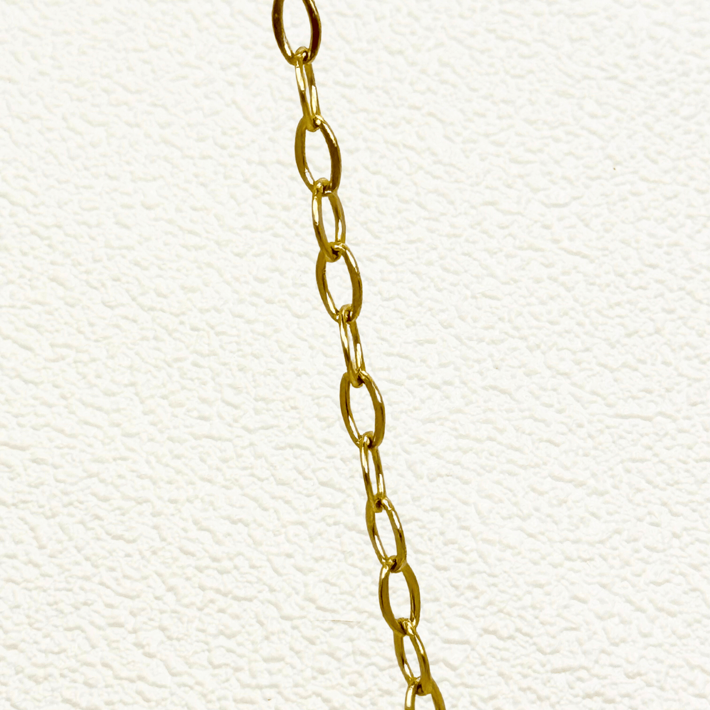 Mini paperclip link chain in 18K gold-plated stainless steel with fine elongated oval links, waterproof and tarnish-resistant, ideal for minimalist layering or adding custom charms