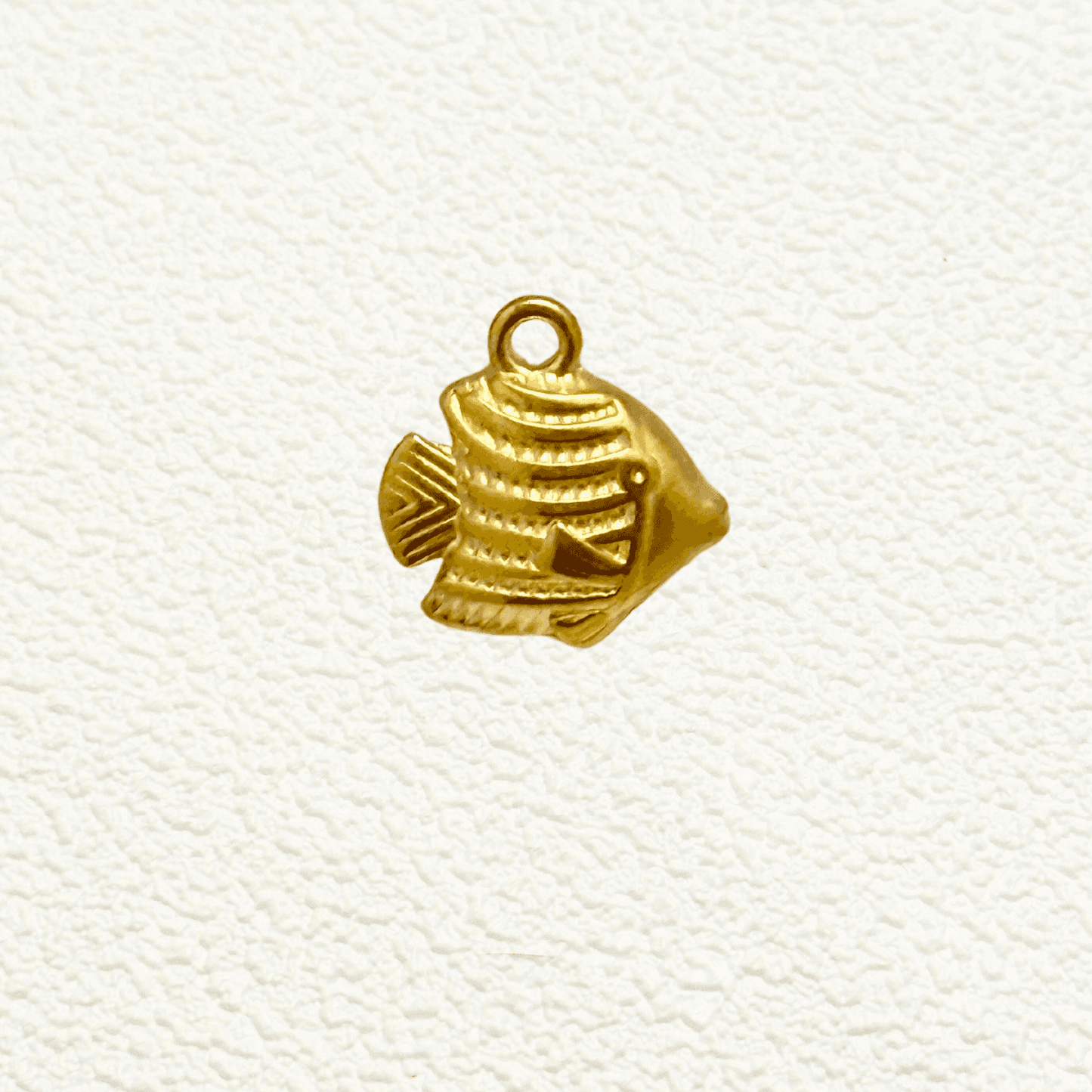 Small gold tropical fish charm with textured detail and solid construction