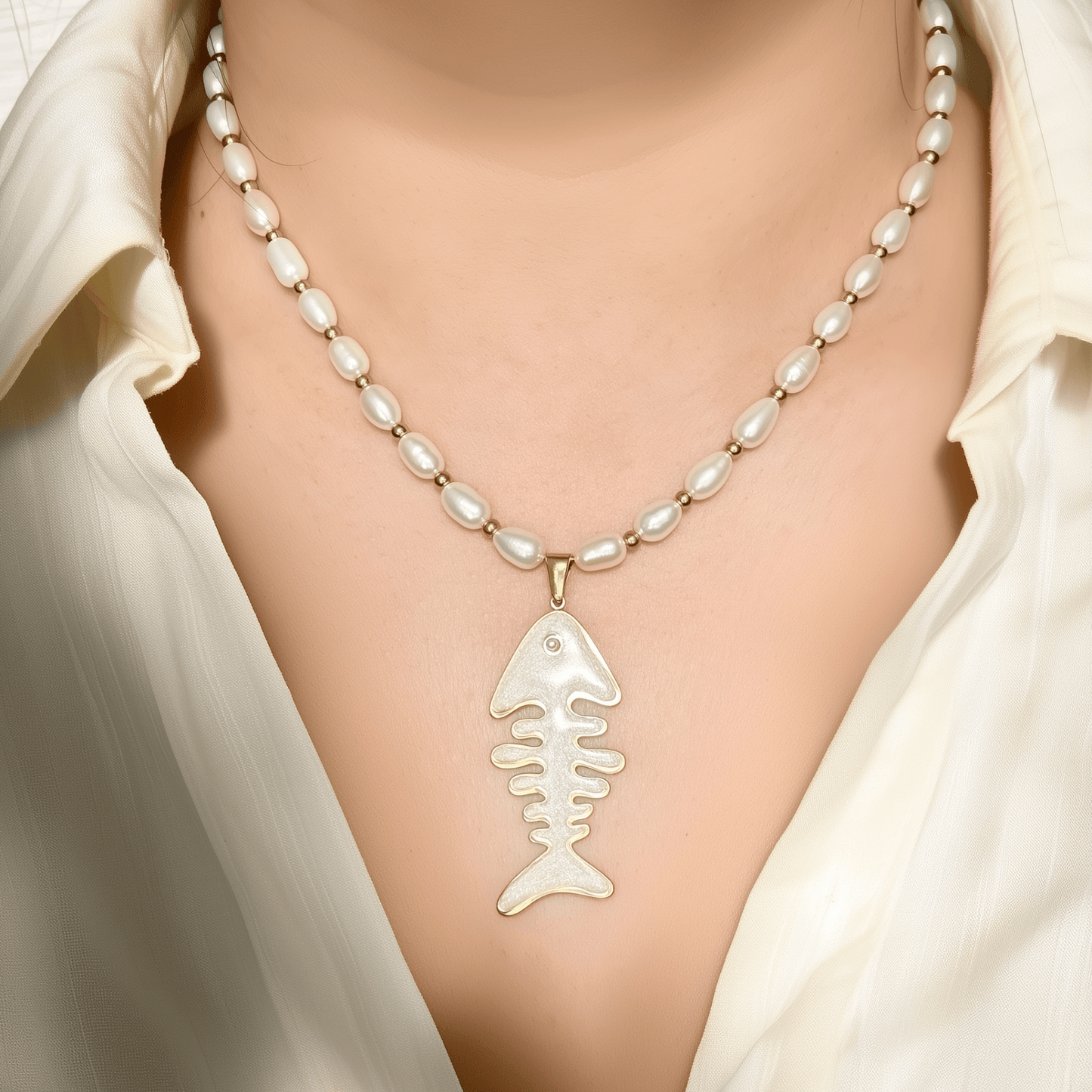 Pearl and gold fishbone necklace symbolising resilience and good fortune