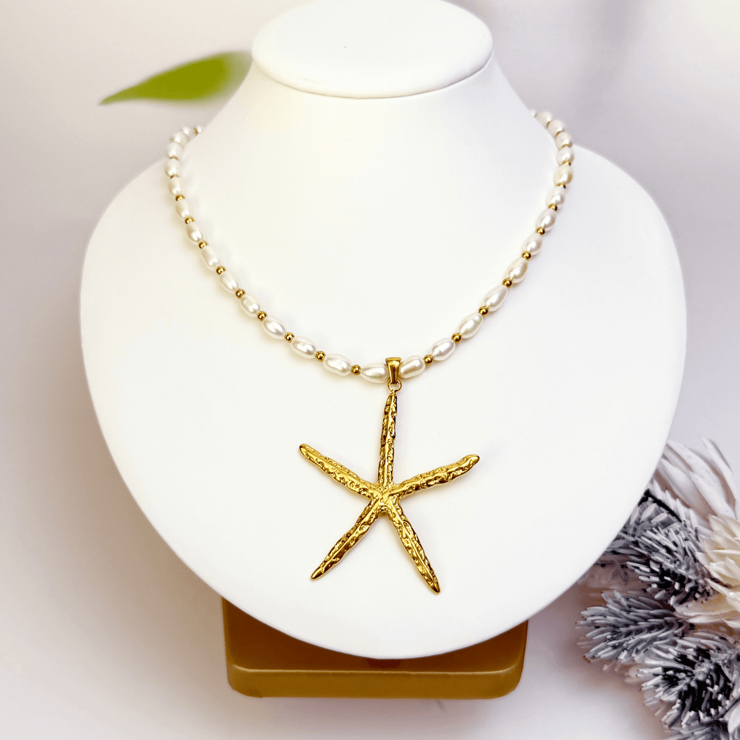 Bold gold starfish pendant on freshwater pearl necklace