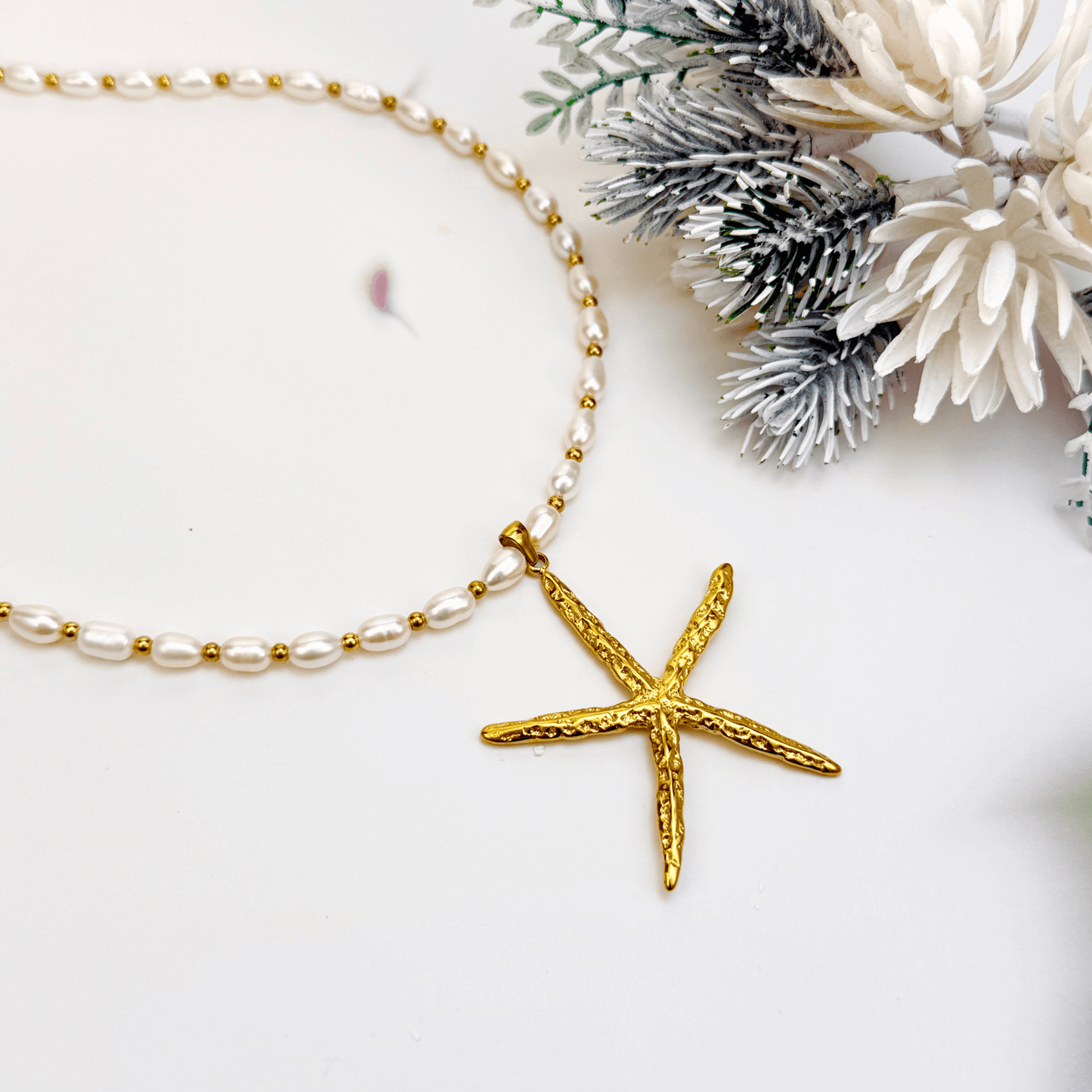 Bold gold starfish pendant on freshwater pearl necklace
