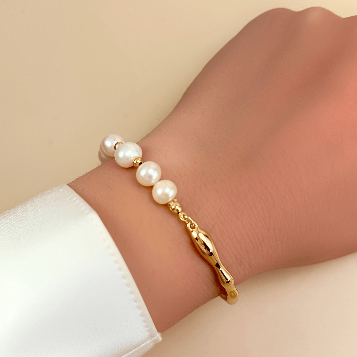 bracelet featuring freshwater pearls and sculptural molten gold band in an open, adjustable design