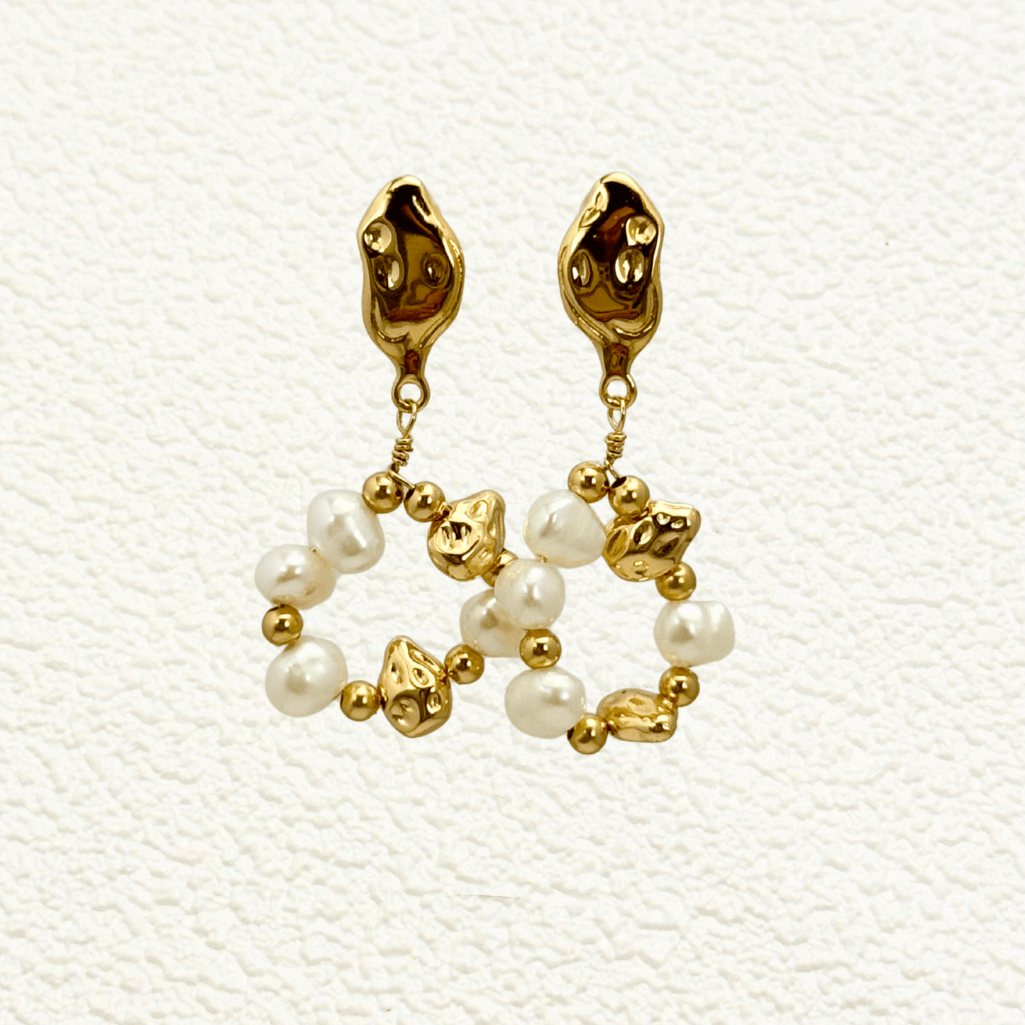 orbit drop earrings with freshwater pearls and molten gold beads in circular design