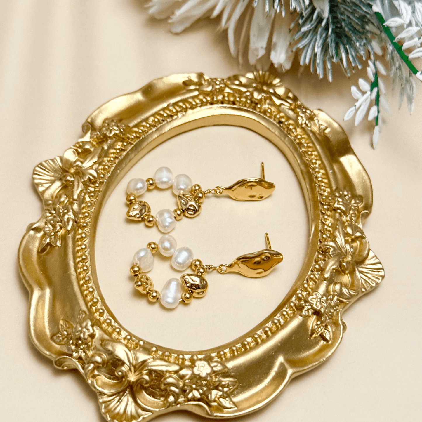 orbit drop earrings with freshwater pearls and molten gold beads in circular design
