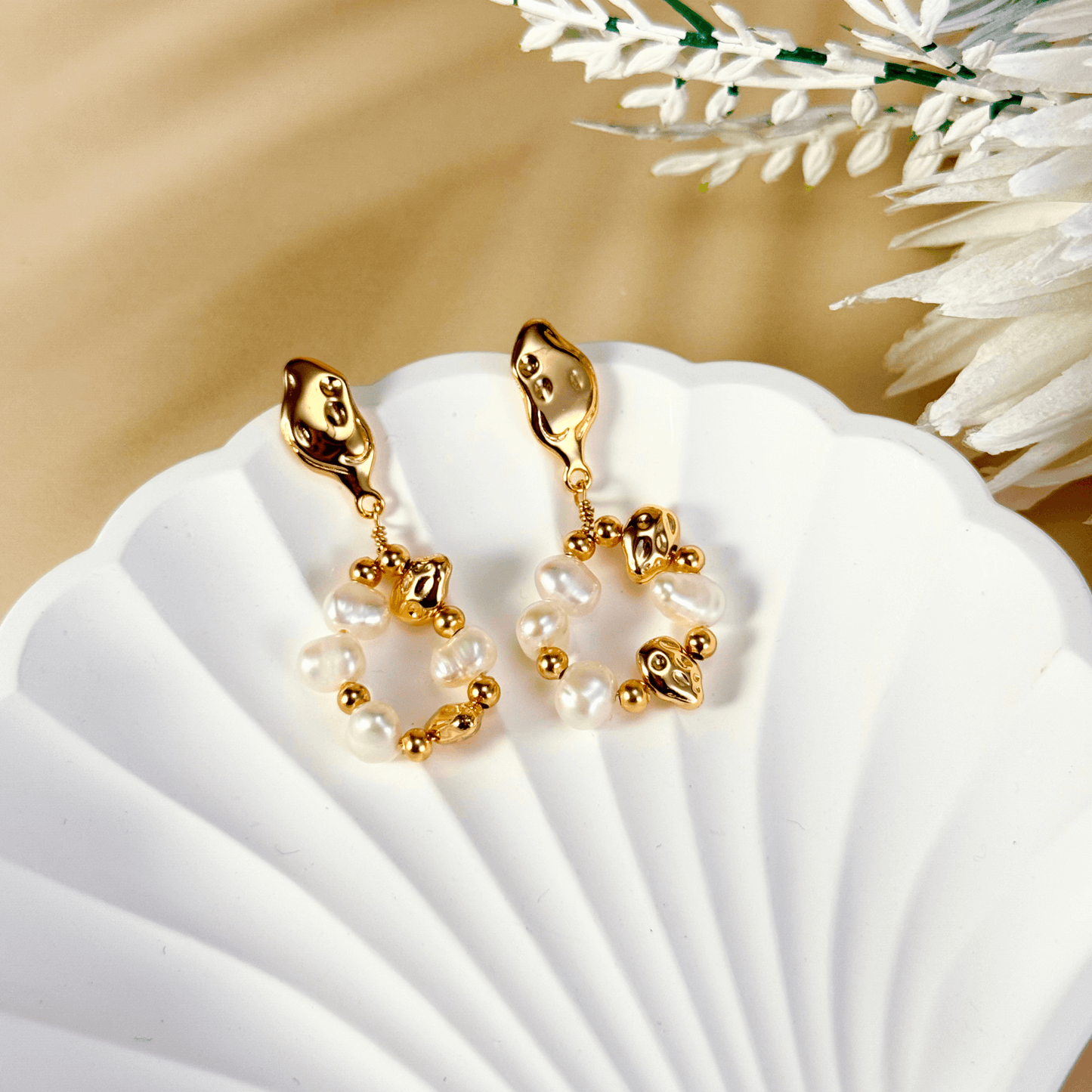 orbit drop earrings with freshwater pearls and molten gold beads in circular design