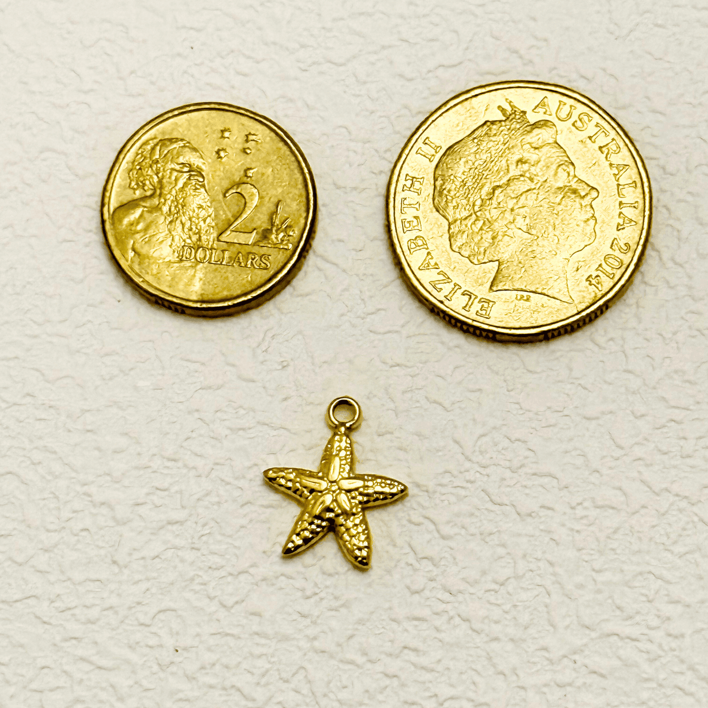 Small textured starfish charm in PVD gold plating, perfect for ocean-themed jewellery