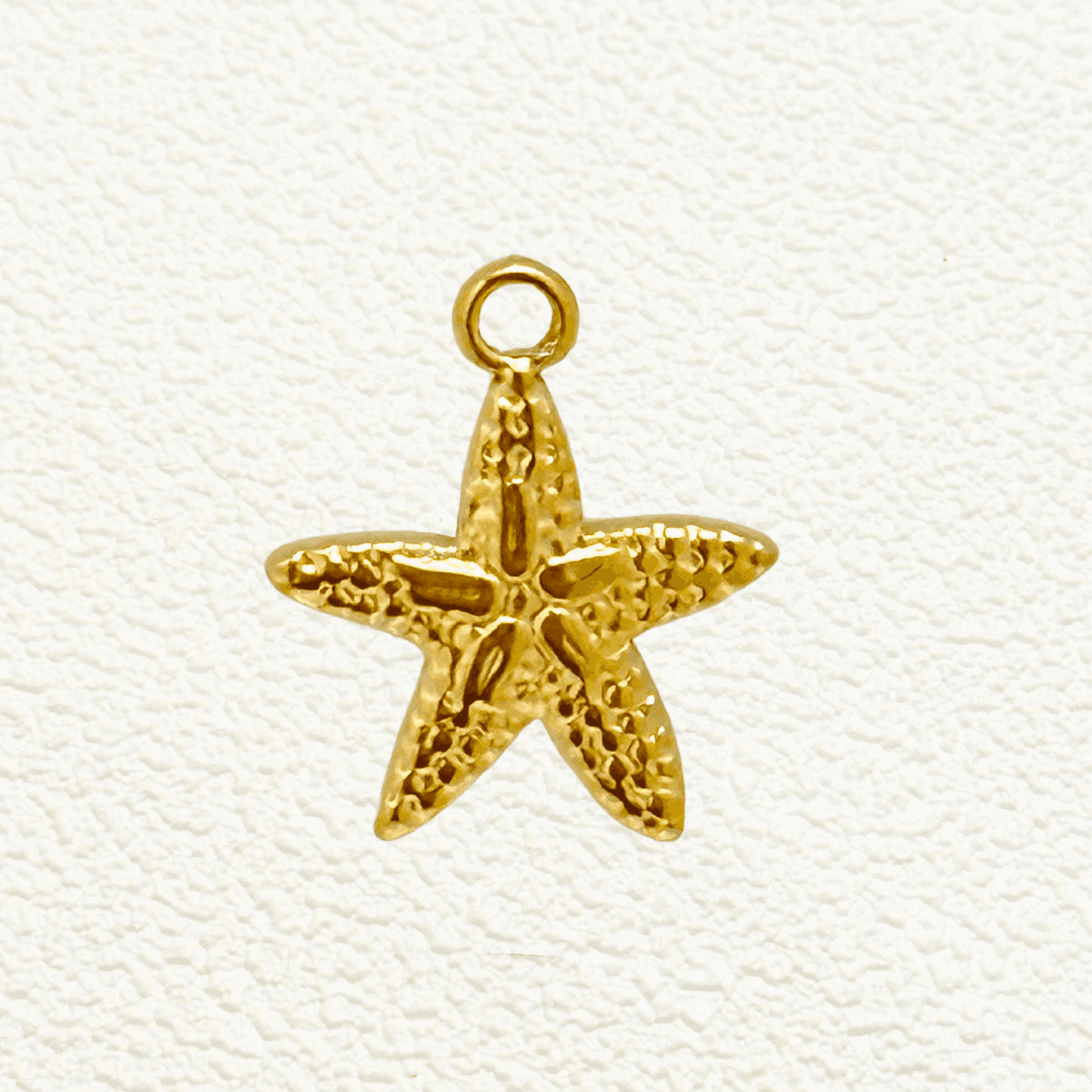 Small textured starfish charm in PVD gold plating, perfect for ocean-themed jewellery