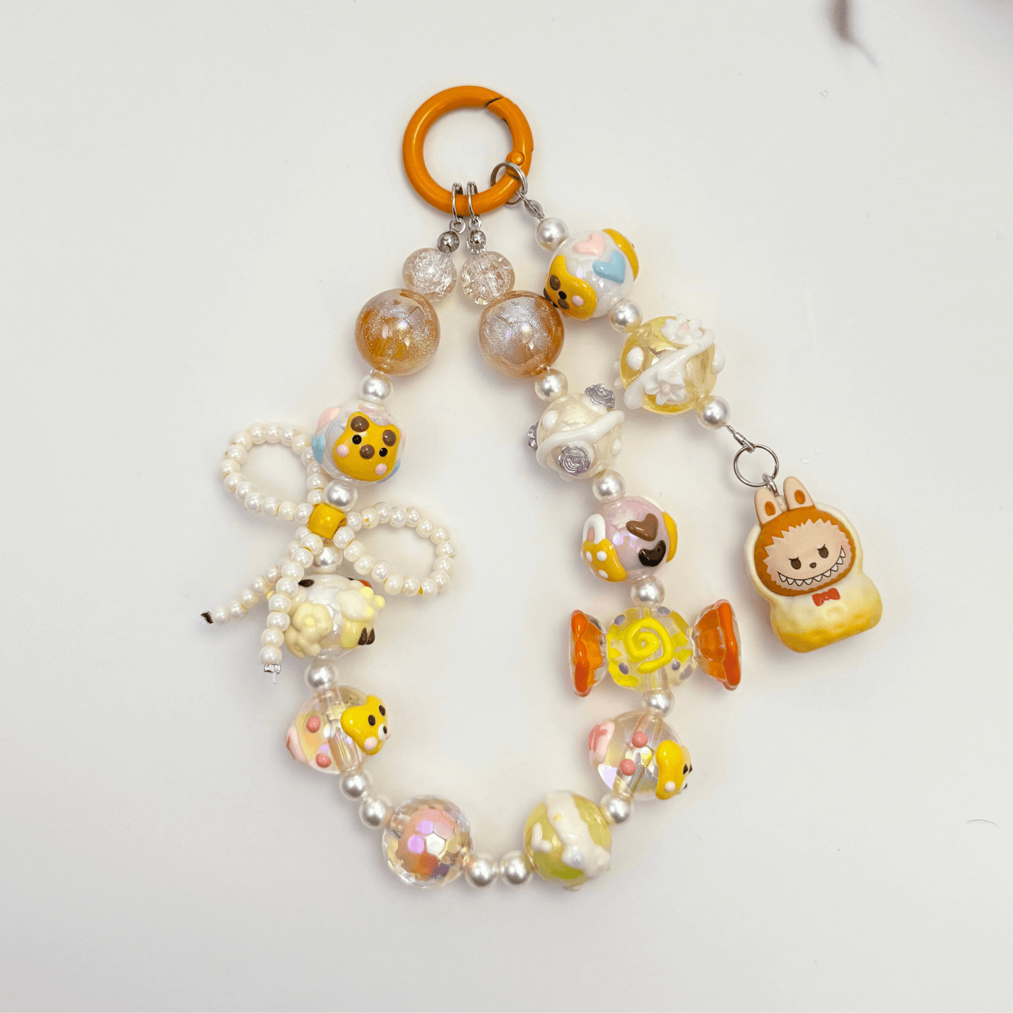 Handmade Labubu-inspired beaded keychains with pearls, glass beads, and colorful character charms – kawaii accessories in pastel and earth tones.