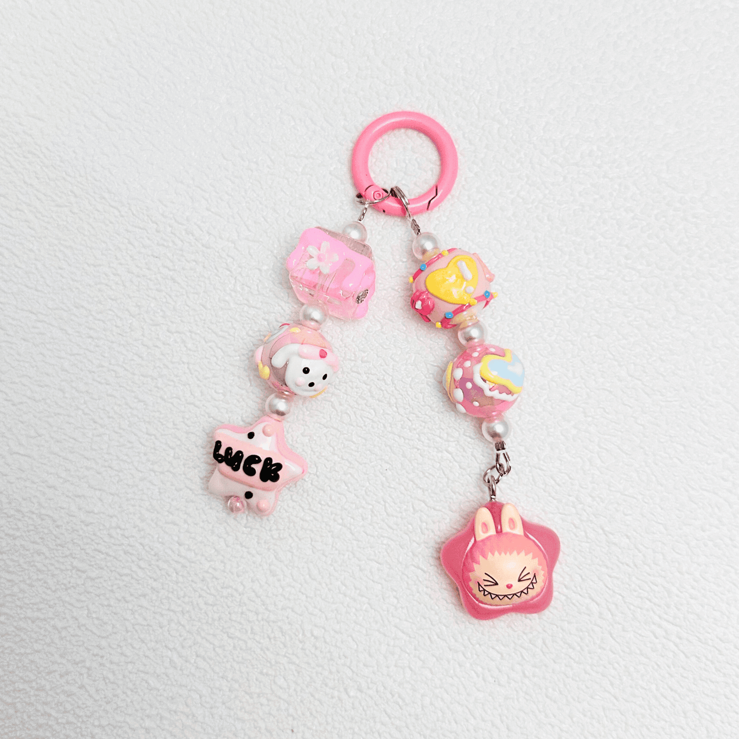 Handmade Pop Bean Labubu phone charm with hand-painted polymer clay beads and faux pearls, attached to a keychain.
