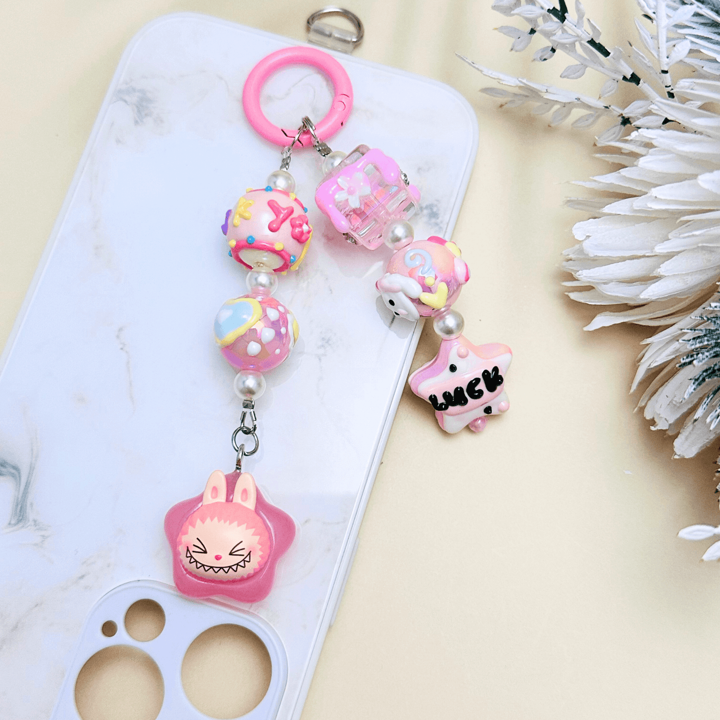 Handmade Pop Bean Labubu phone charm with hand-painted polymer clay beads and faux pearls, attached to a keychain.