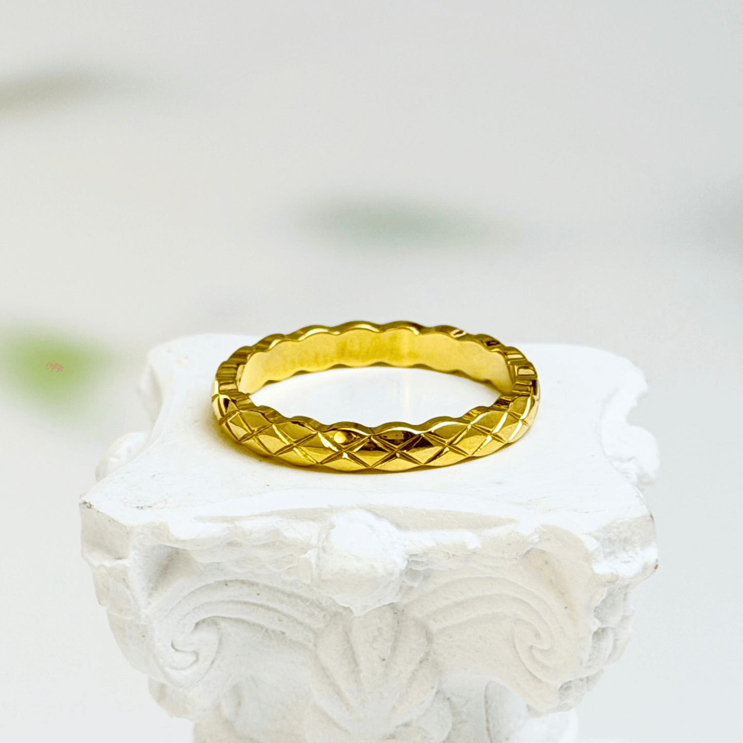 Slim quilted gold band ring with textured designer-inspired pattern.