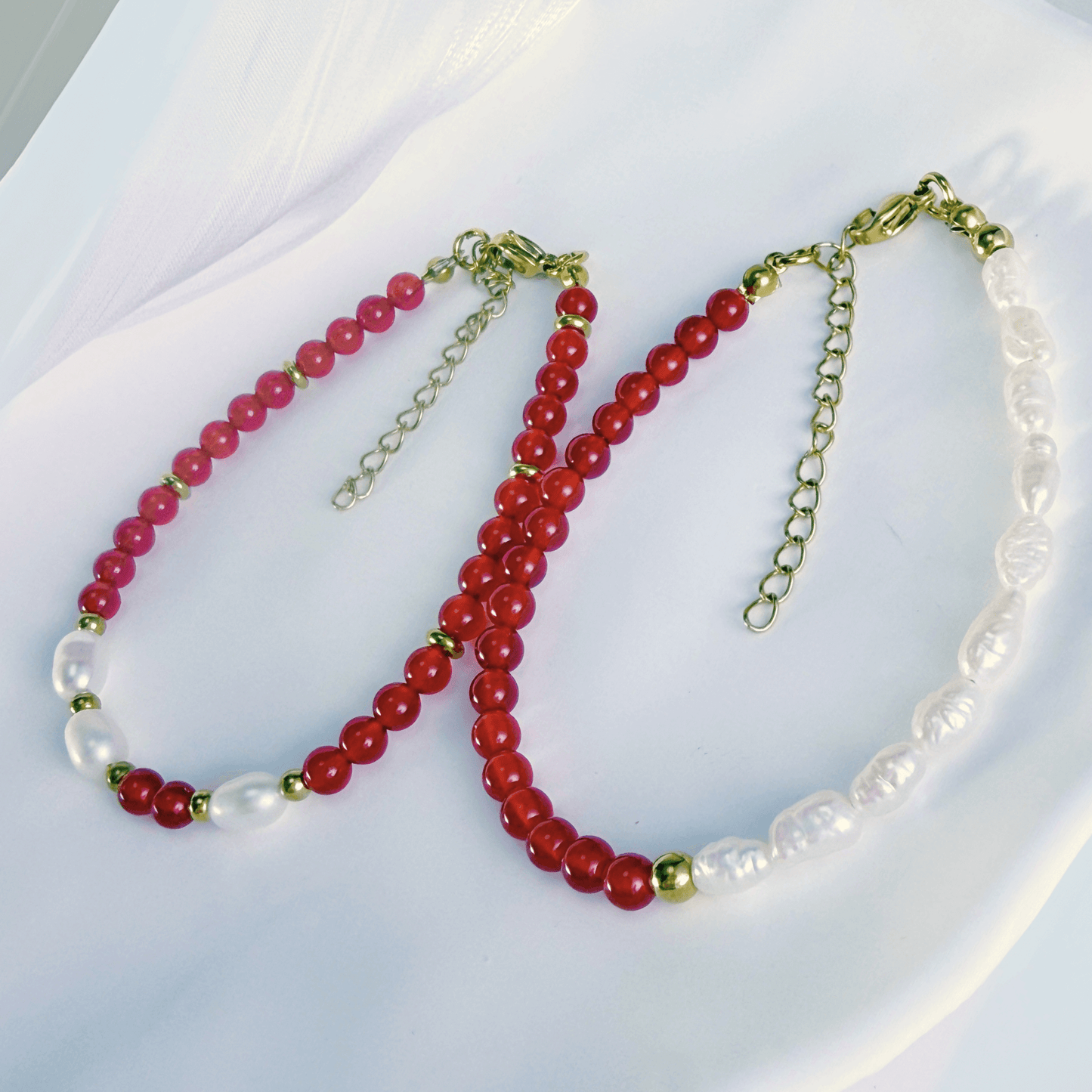 Handmade bracelet with red agate beads and freshwater pearl accents, finished with gold or silver findings.
