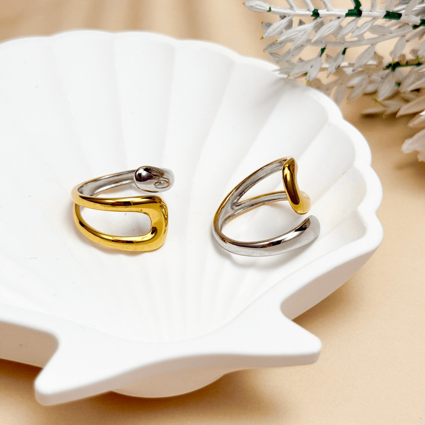 Sculpted Arc Ring in gold and silver, featuring a curved open-band design with smooth, reflective finish. Waterproof and hypoallergenic, worn as a modern statement ring.