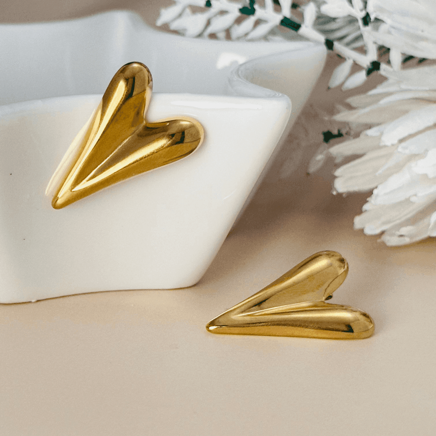 Sculpted gold heart earrings with a bold statement design, crafted in 18K gold-plated stainless steel. Waterproof and hypoallergenic.