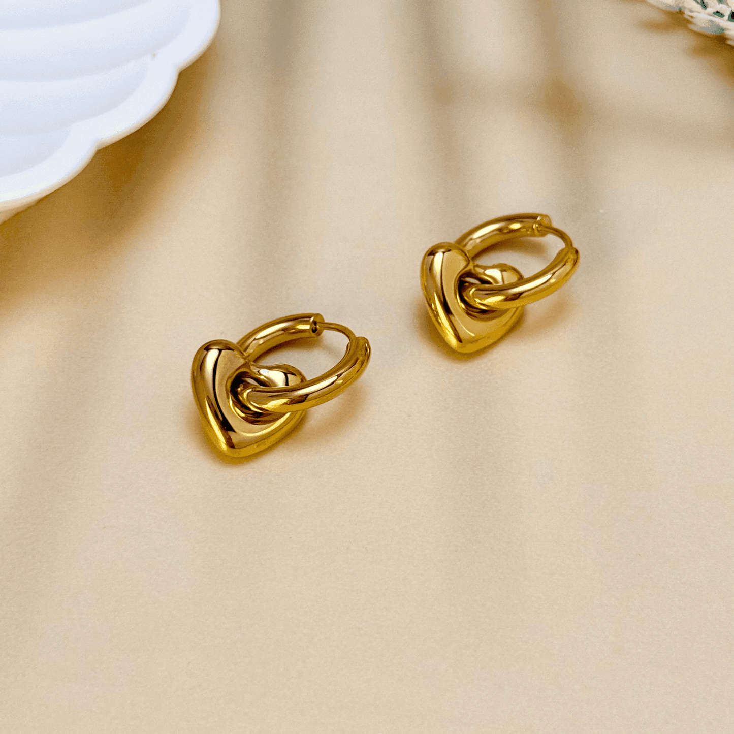 Gold sculpted heart charm hoop earrings made from stainless steel with polished PVD plating – elegant and waterproof minimalist jewellery