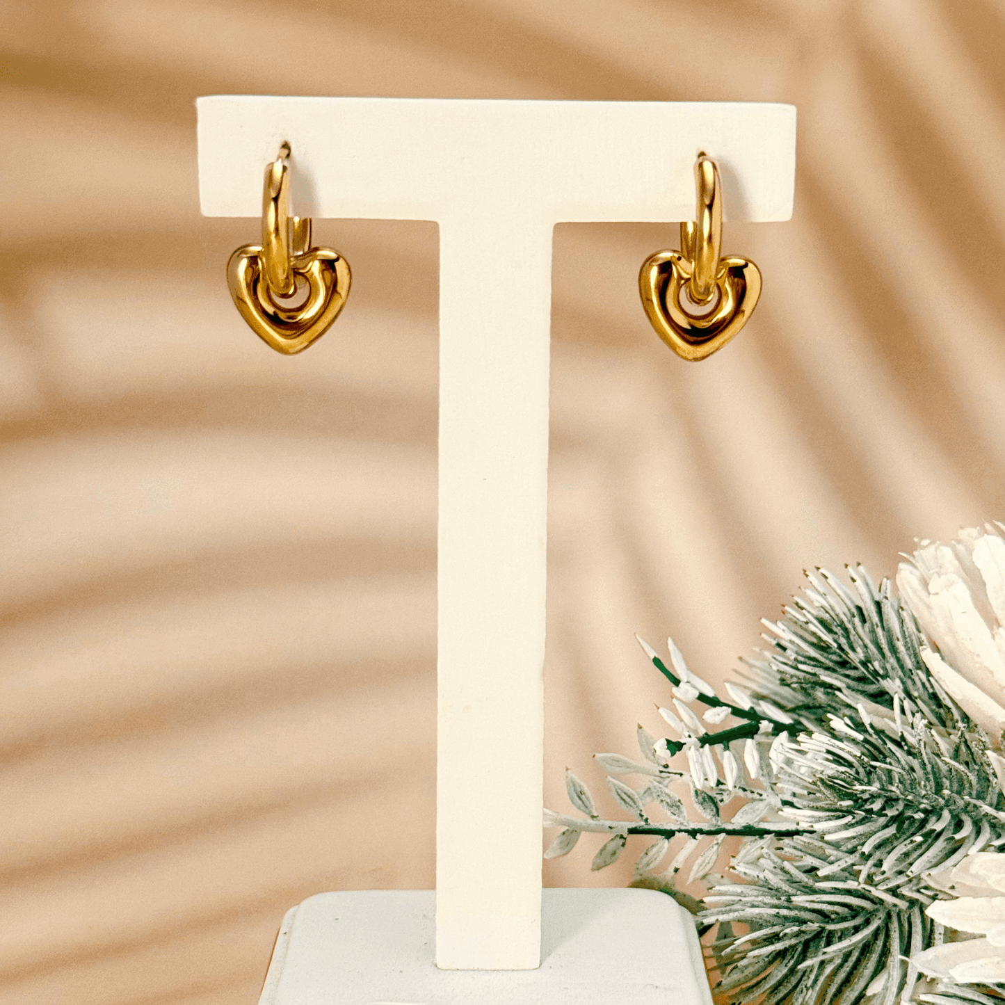 Gold sculpted heart charm hoop earrings made from stainless steel with polished PVD plating – elegant and waterproof minimalist jewellery