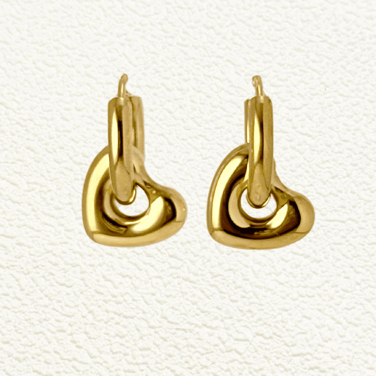 Gold sculpted heart charm hoop earrings made from stainless steel with polished PVD plating – elegant and waterproof minimalist jewellery