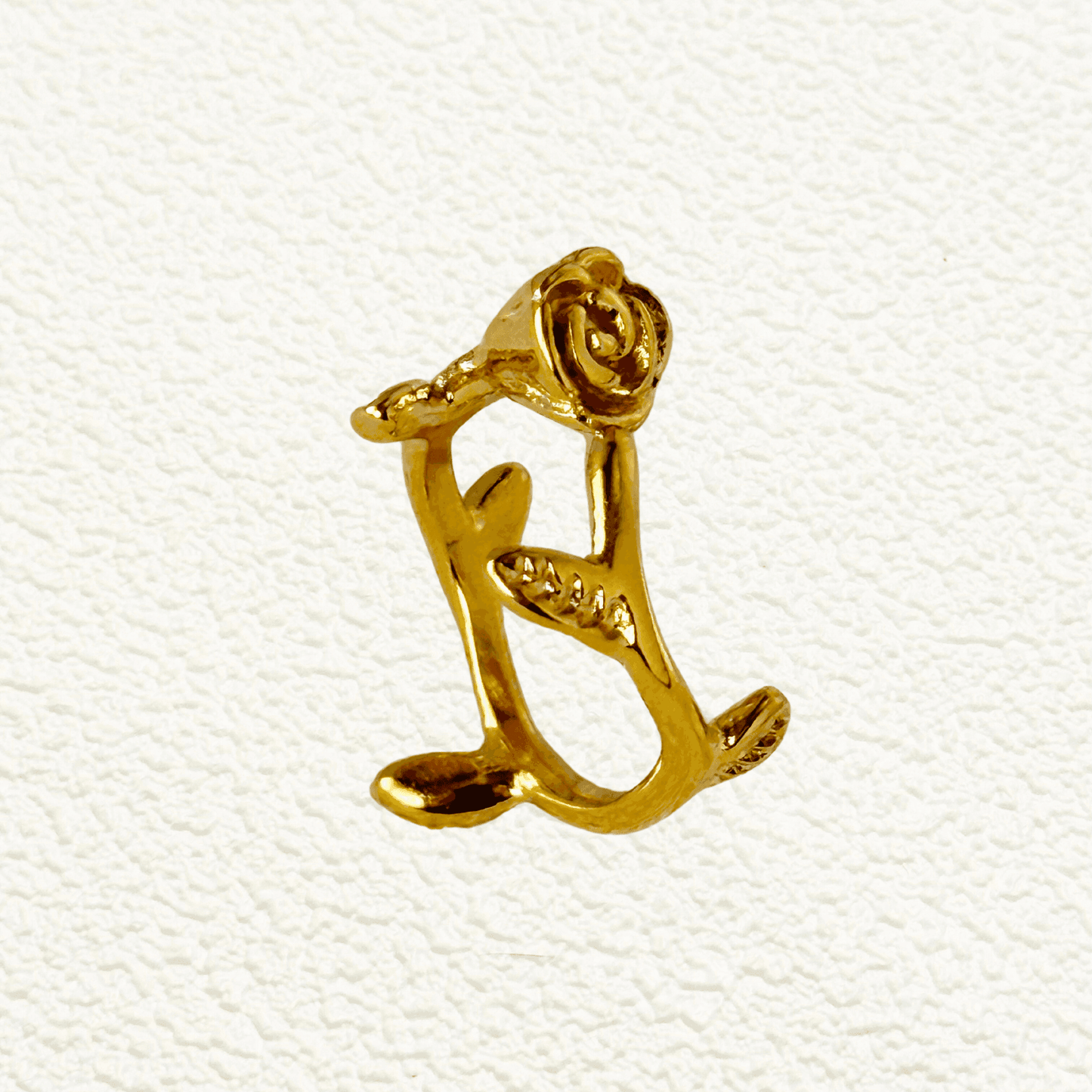 Gold sculpted rose vine ring in stainless steel with open adjustable design and leaf detail – romantic floral statement jewellery