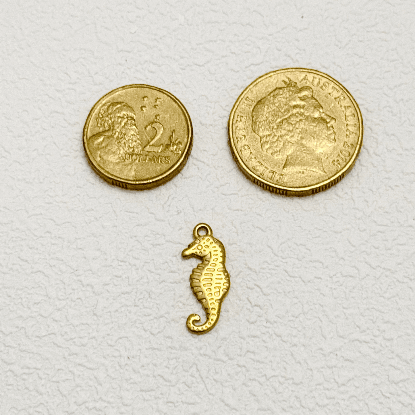 Gold Sculpted Spine Seahorse Charm with curled tail and detailed texture