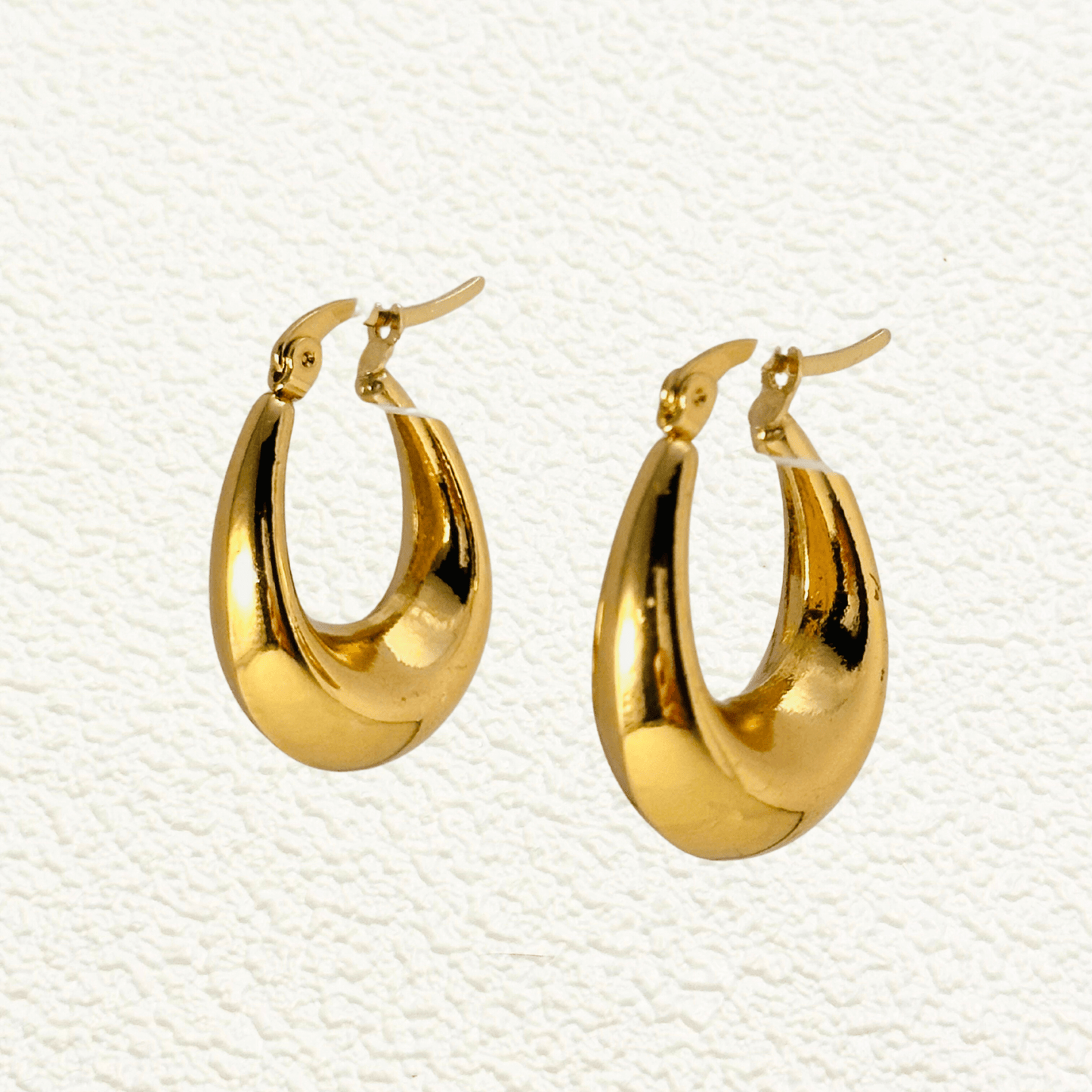 Sculptural gold hoop earrings, waterproof & tarnish-resistant statement jewellery.