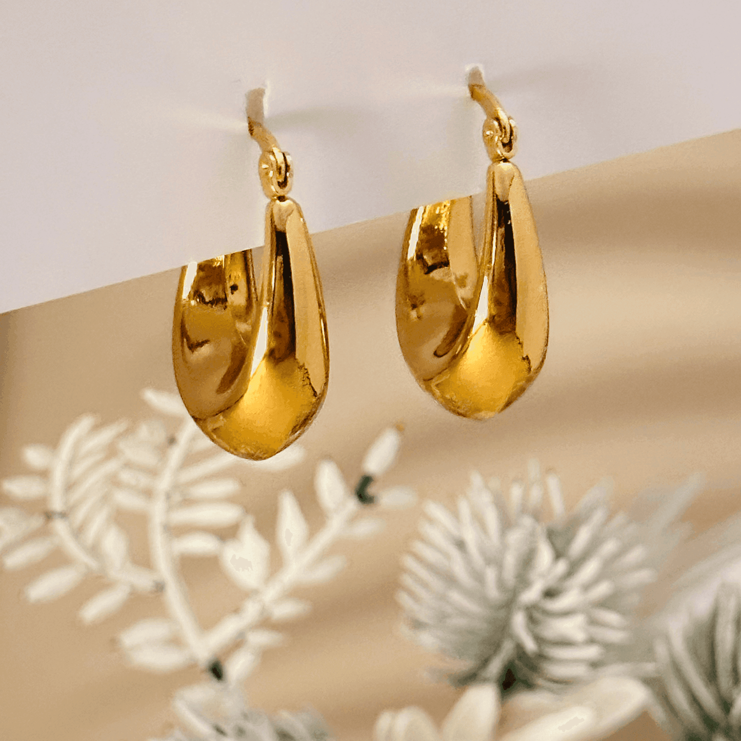 Sculptural gold hoop earrings, waterproof & tarnish-resistant statement jewellery.