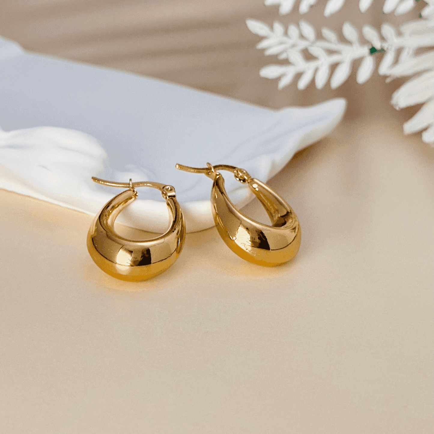Sculptural gold hoop earrings, waterproof & tarnish-resistant statement jewellery.