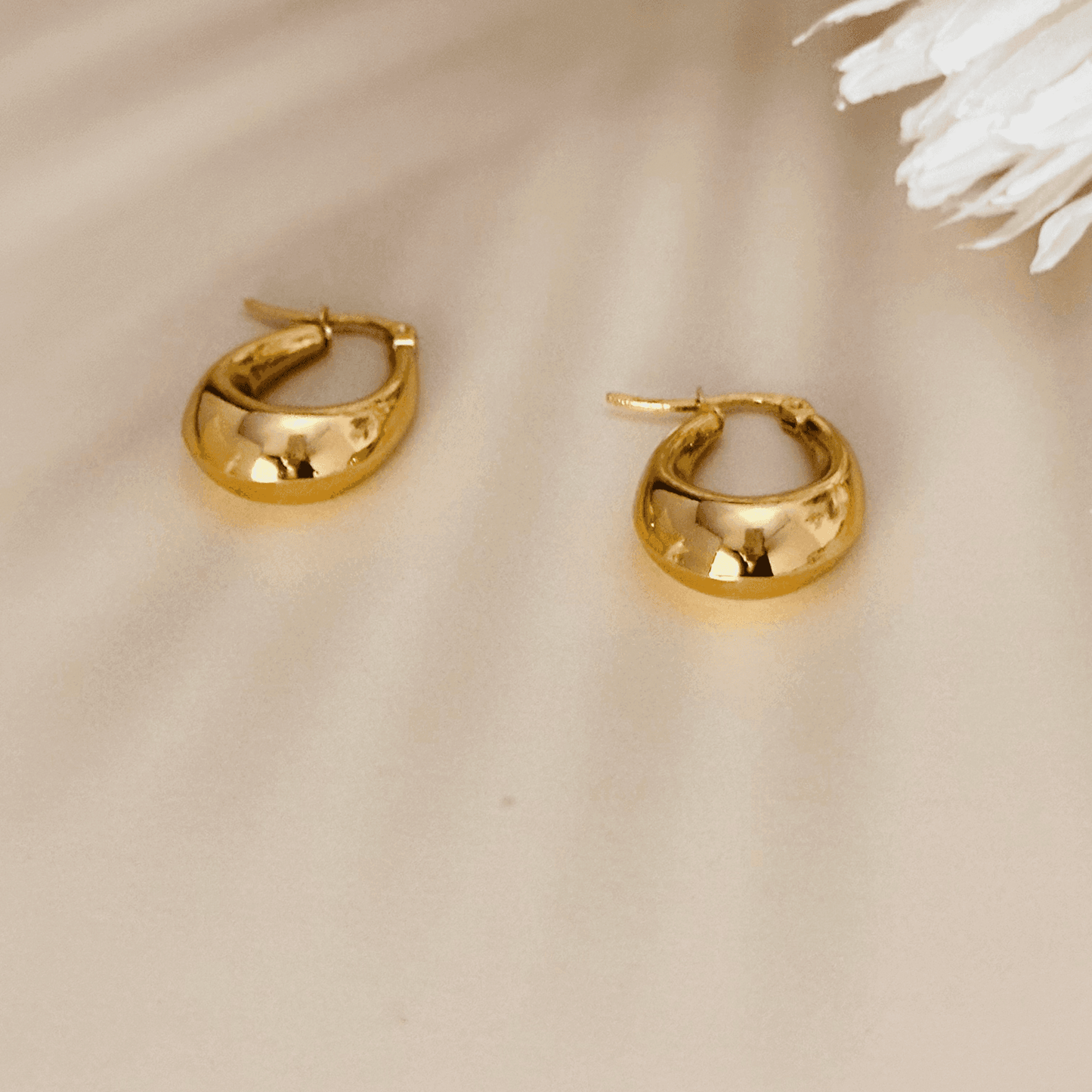 Sculptural gold hoop earrings, waterproof & tarnish-resistant statement jewellery.