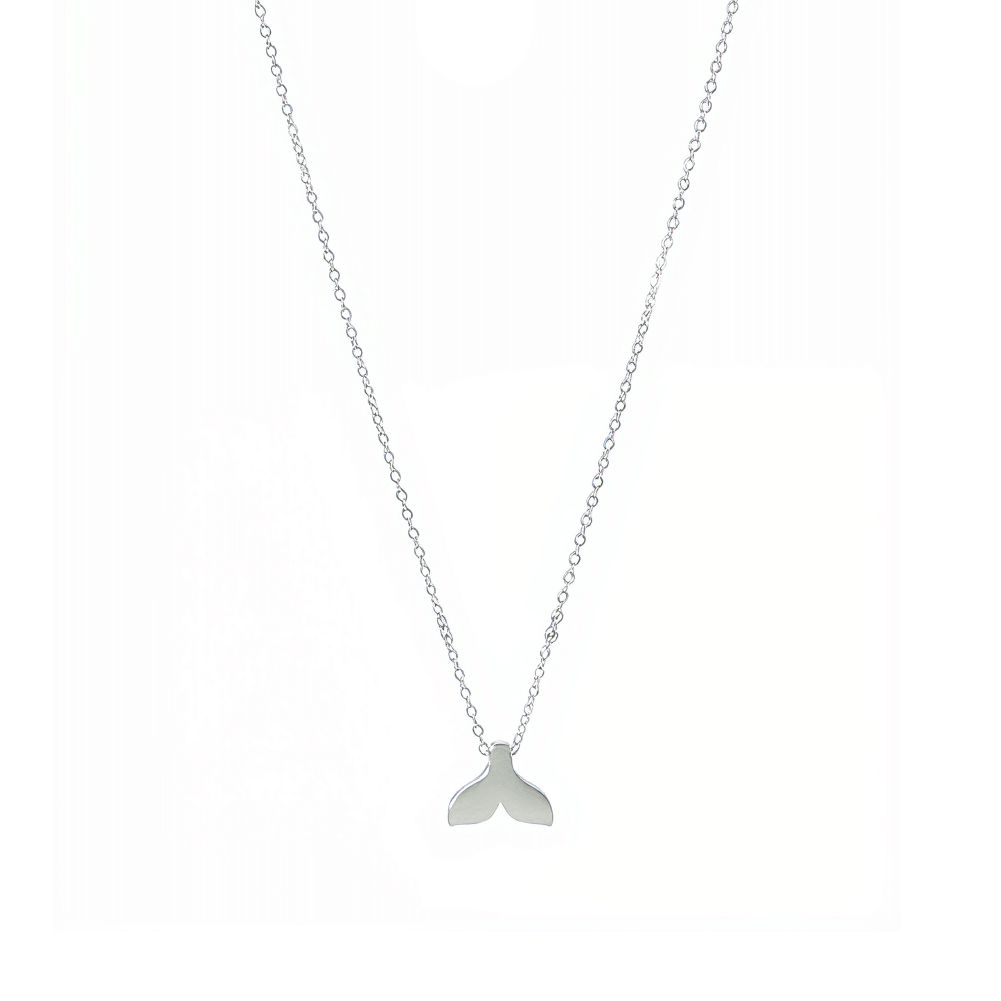 Silver whale tail pendant necklace representing freedom and ocean grace.
