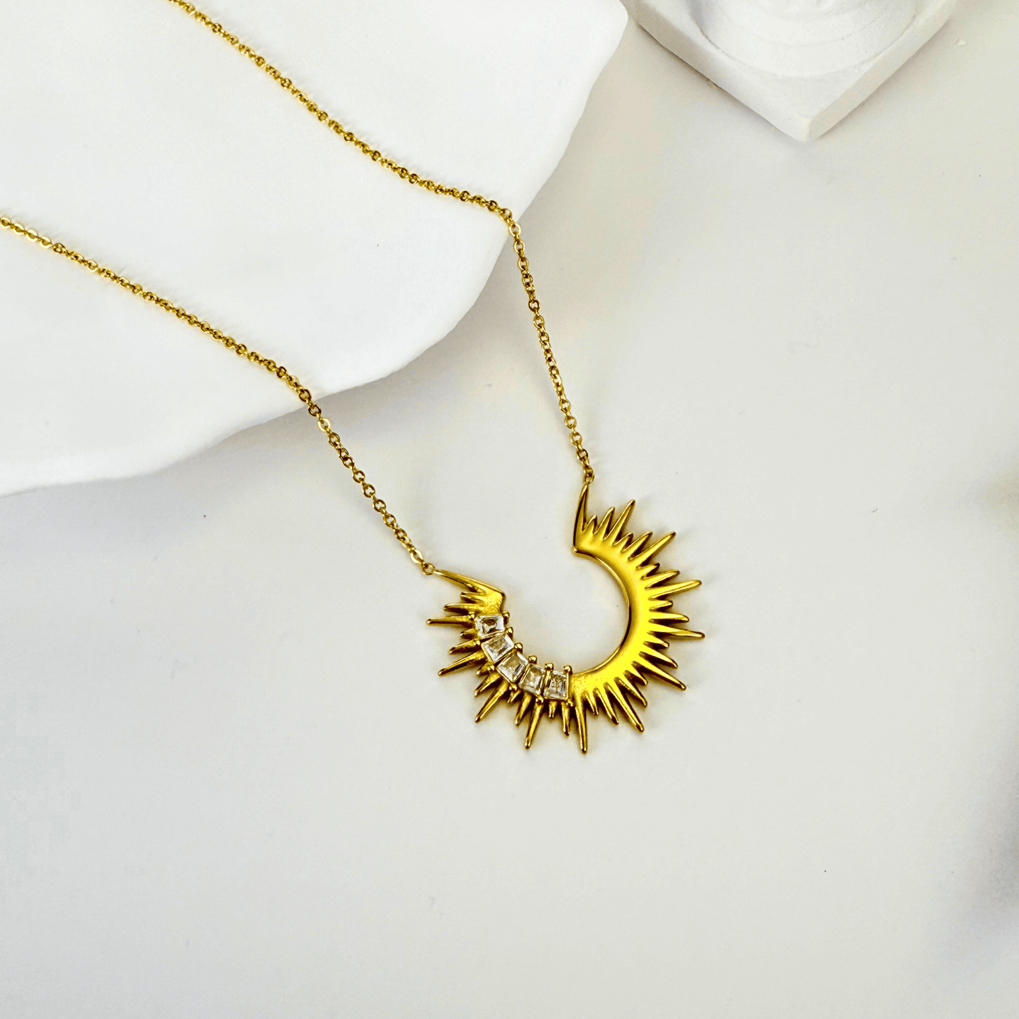 Waterproof sparkling sunburst necklace with a radiant crescent pendant in 18K PVD gold, accented with cubic zirconia