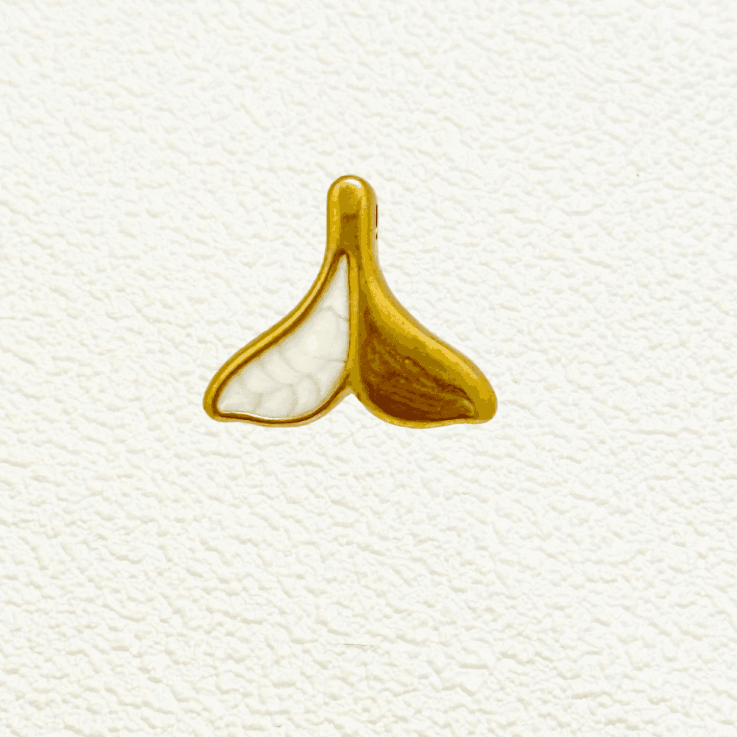 Gold whale tail charm with white enamel split design – ocean-themed pendant