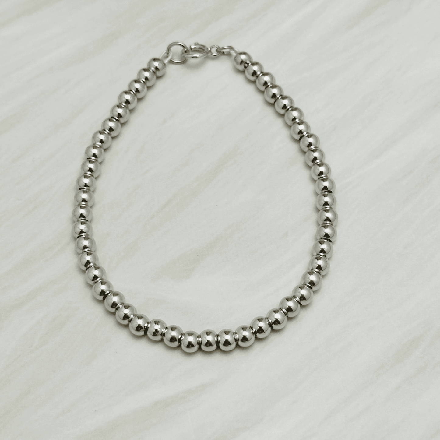 Personalised Swarovski birthstone beaded bracelet in gold-filled and sterling silver options, waterproof and customisable design by MXW Jewellery.
